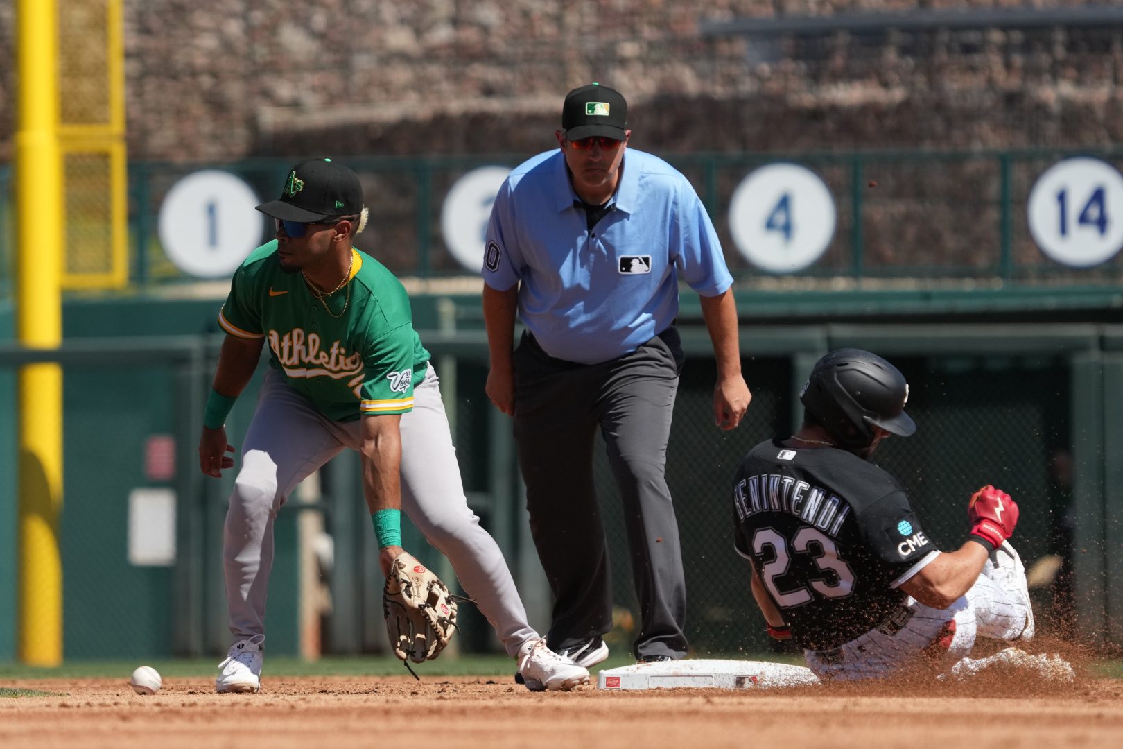 Chicago White Sox left fielder Andrew Benintendi steals second base as Athletics third baseman Darell Hernaiz applies a tag during the second inning at Camelback Ranch-Glendale on March 17, 2026.