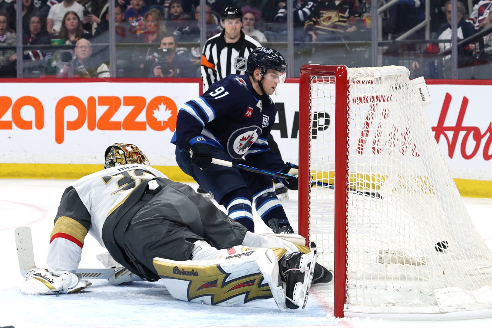 Winnipeg Jets center Cole Perfetti scores in front of Vegas goaltender Adin Hill during the second period at Canada Life Centre on March 24, 2026.