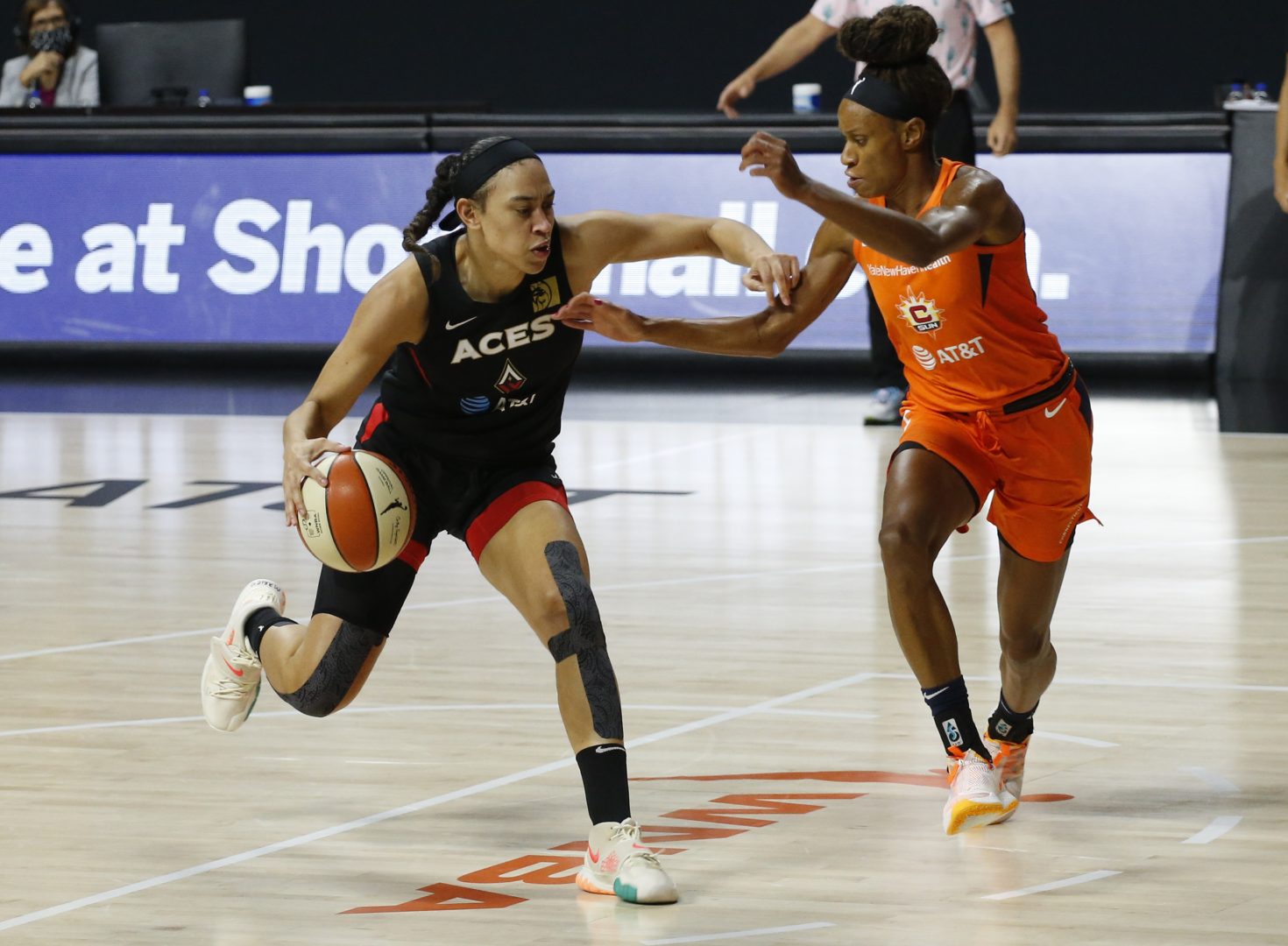 Las Vegas Aces forward Dearica Hamby drives past Connecticut Sun guard Jasmine Thomas during a 2020 WNBA game