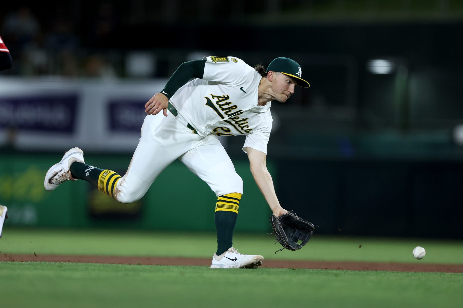 Las Vegas Aviators infielder Zack Gelof charges a ground ball and throws to first during an Athletics game at Sutter Health Park in West Sacramento, California.