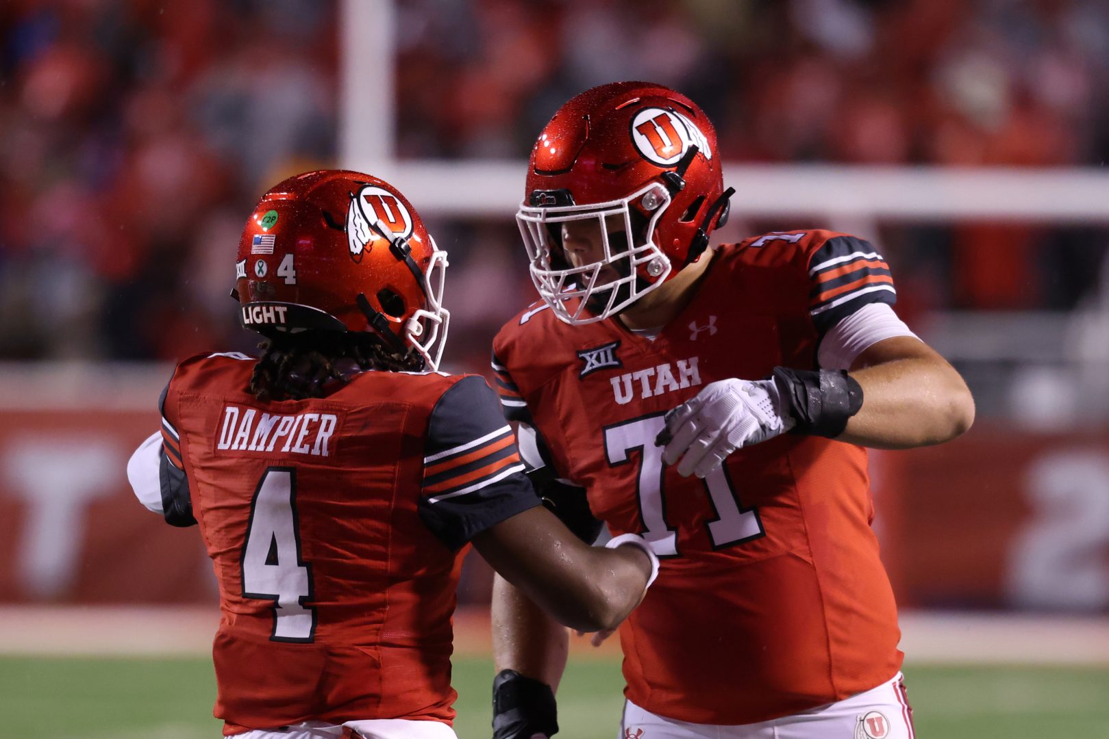Utah offensive lineman Caleb Lomu celebrates with QB Devon Dampier after a touchdown against Arizona State.
