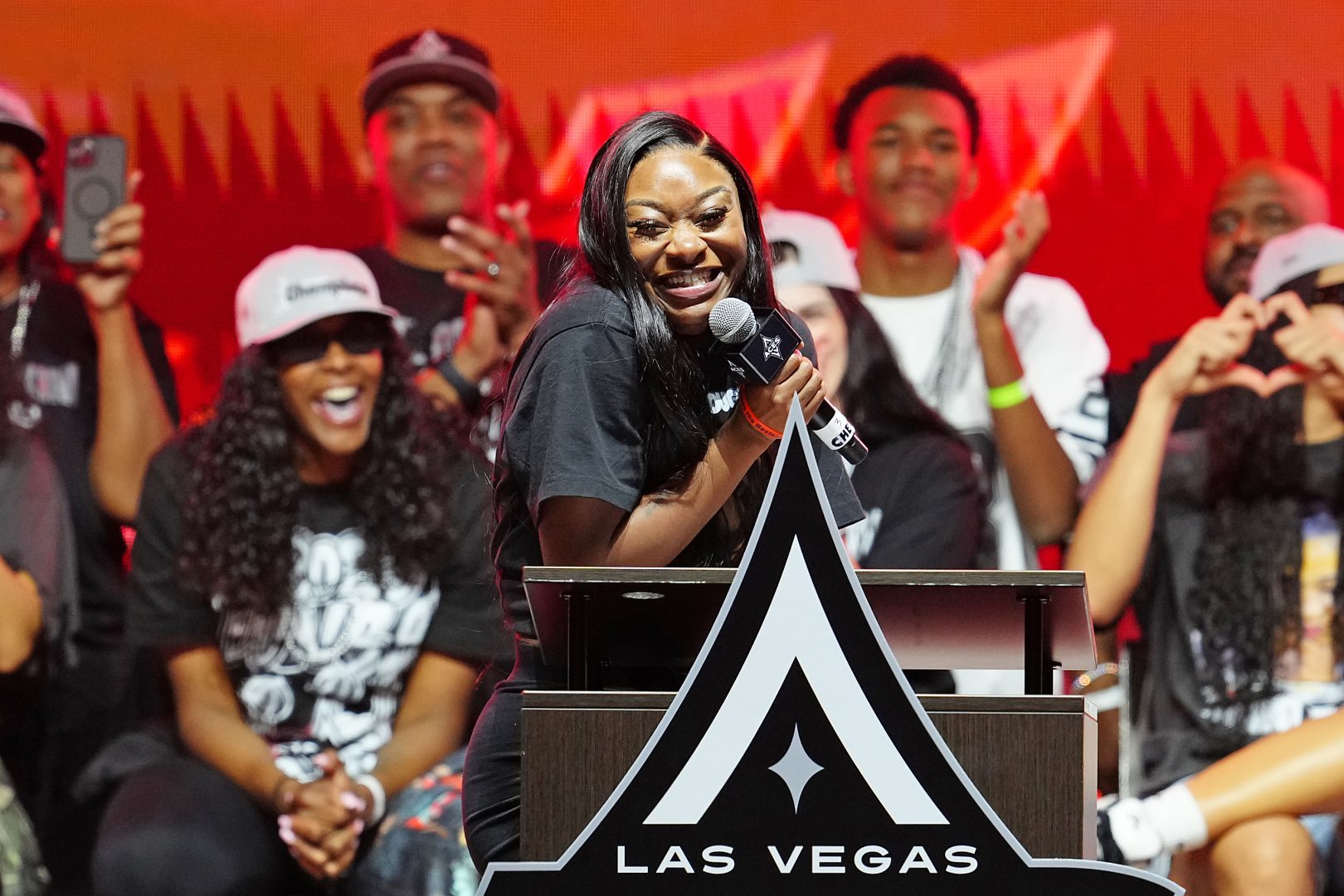 Dana Evans talks with Aces fans during the 2025 WNBA championship celebration at Toshiba Plaza in Las Vegas.