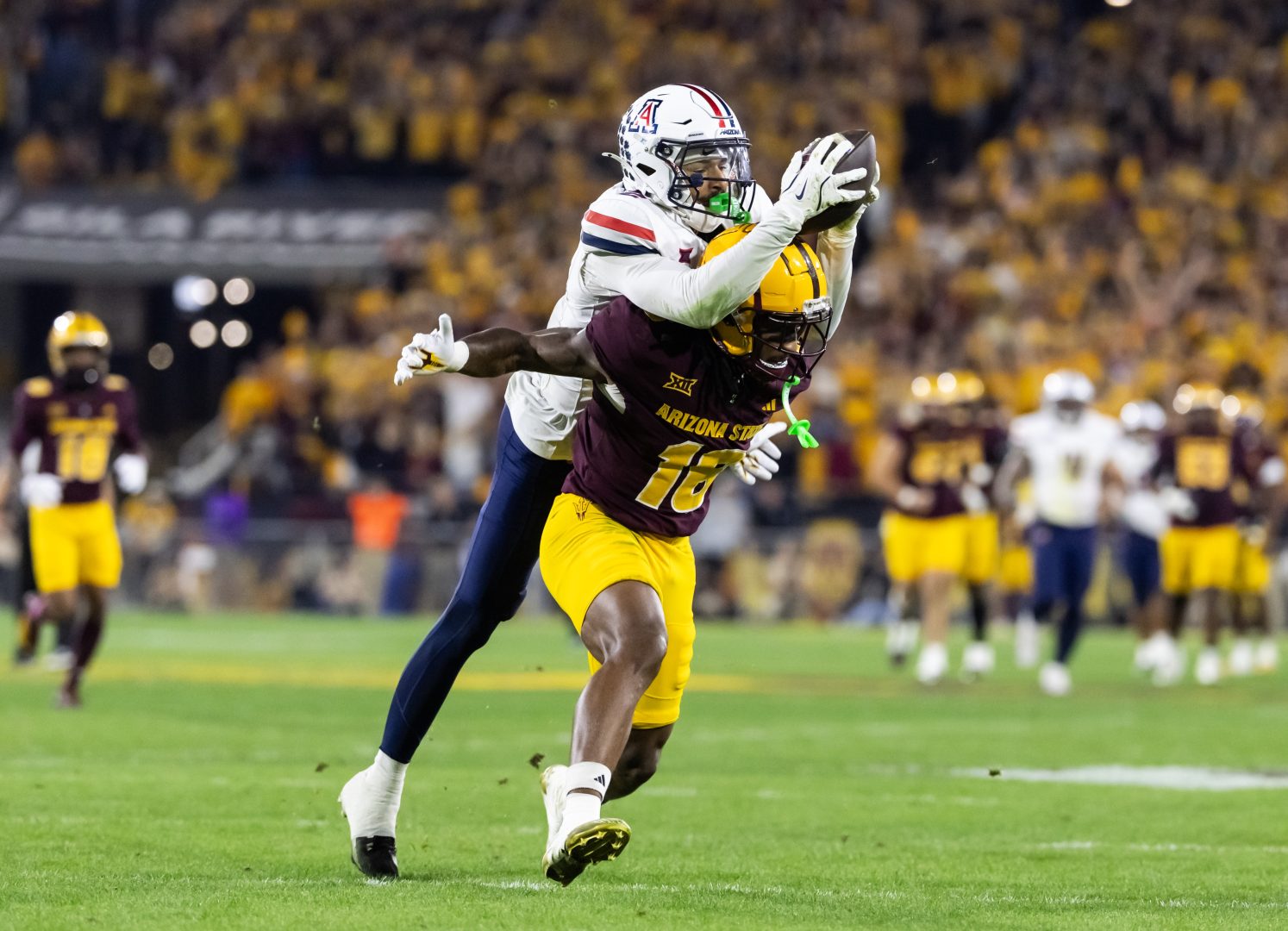 Arizona DB Treydan Stukes intercepts a pass against Arizona State in the Territorial Cup.