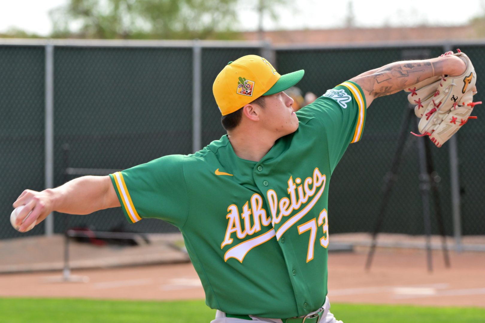 Chen Zhong-Ao Zhuang throws a pitch during an Athletics Spring Training workout in Mesa, Arizona.