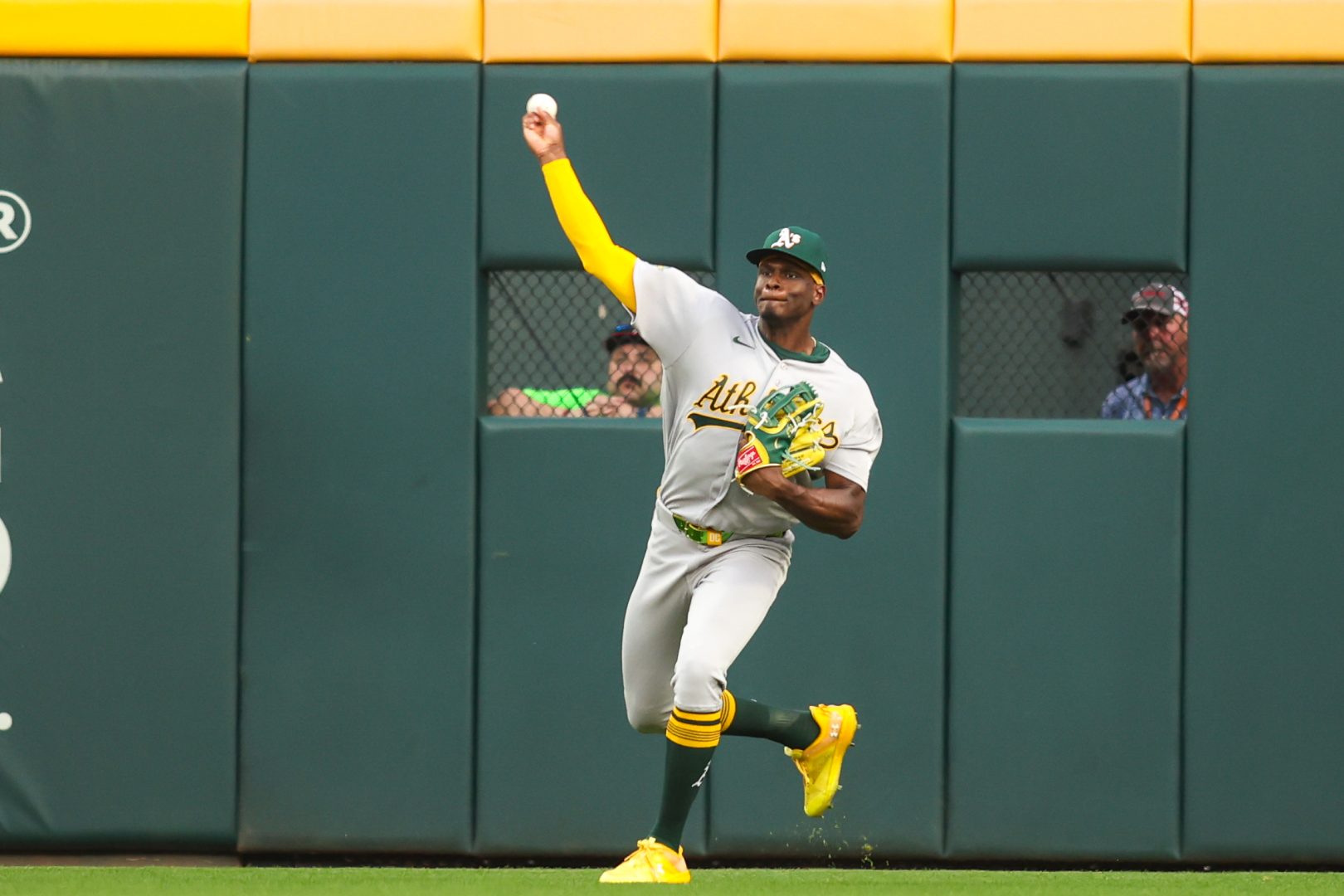 Athletics center fielder Denzel Clarke throws the ball during the first inning against the Atlanta Braves at Truist Park.
