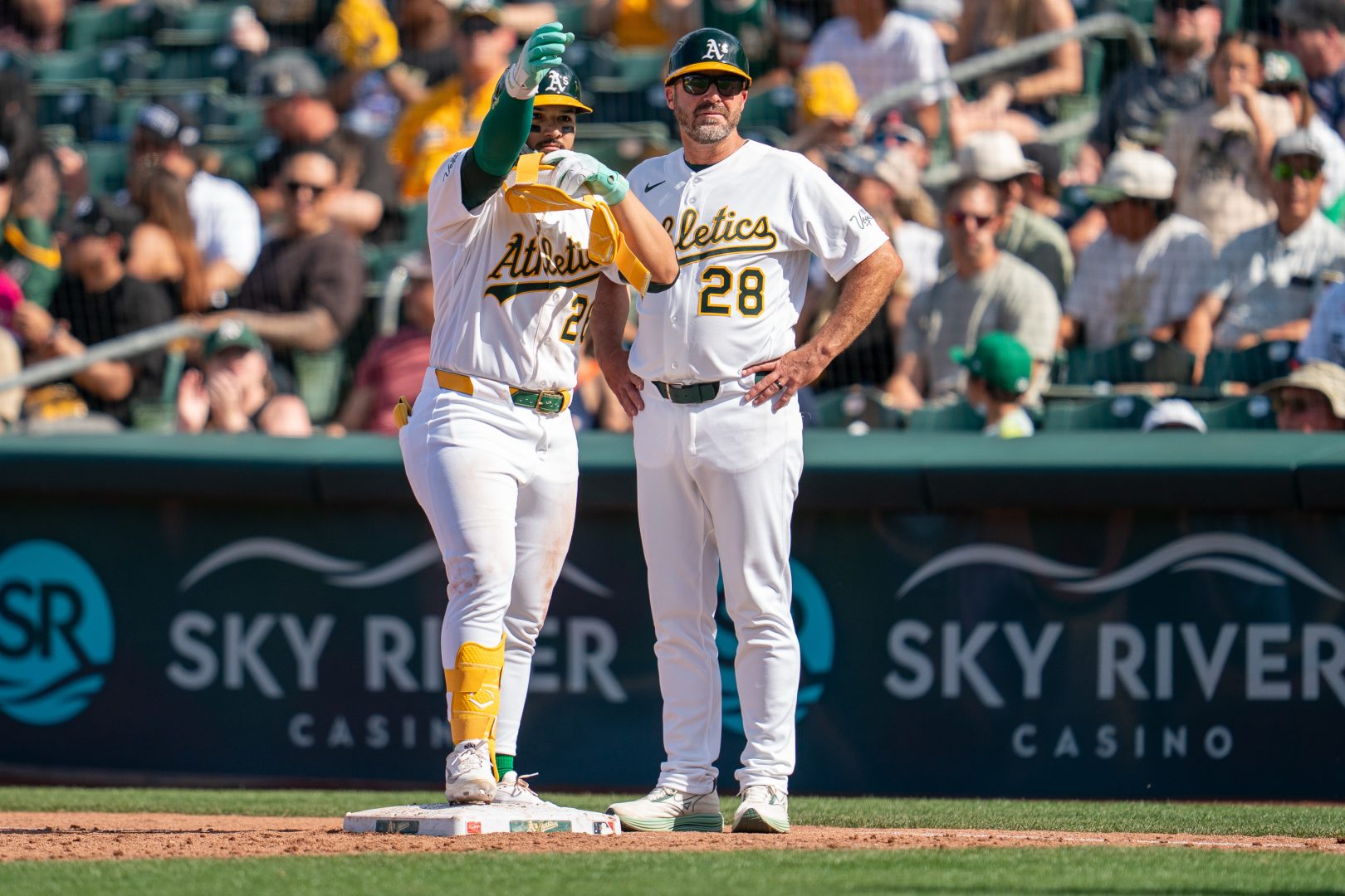 Carlos Cortes celebrates on first base after a two-run single for the Athletics against the Astros at Sutter Health Park.