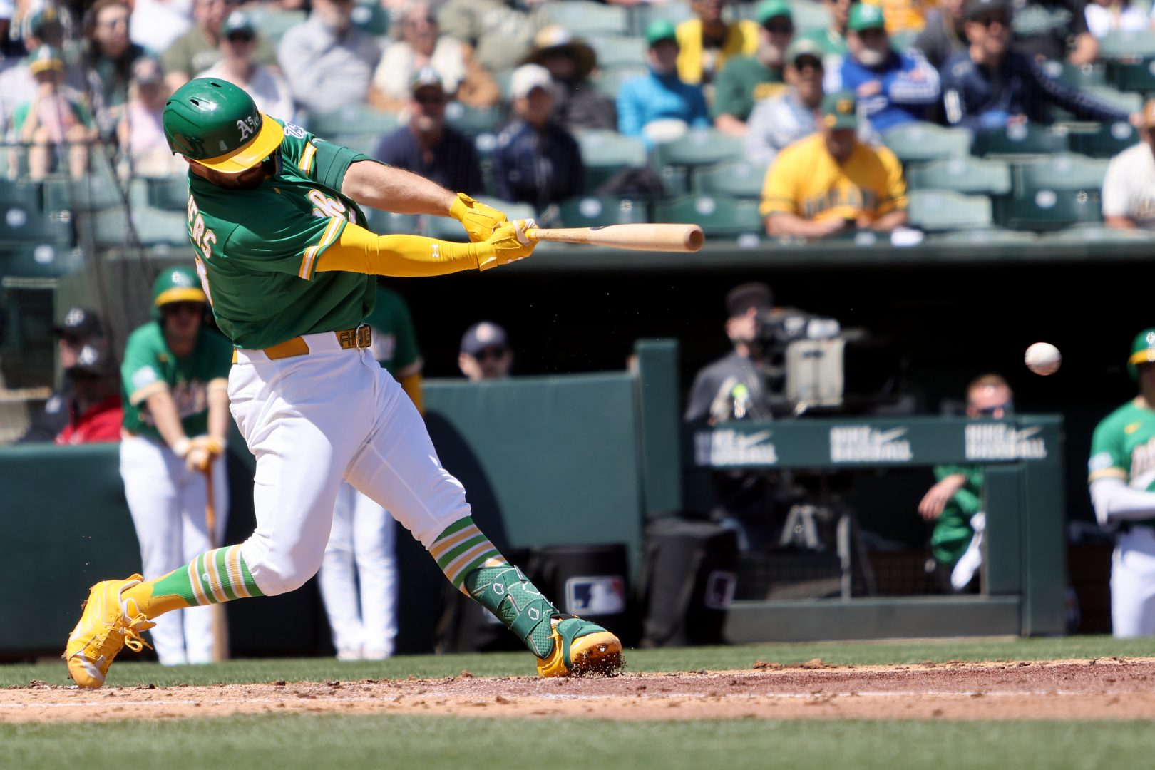 Athletics designated hitter Shea Langeliers lines a single during the third inning against the Texas Rangers at Sutter Health Park.