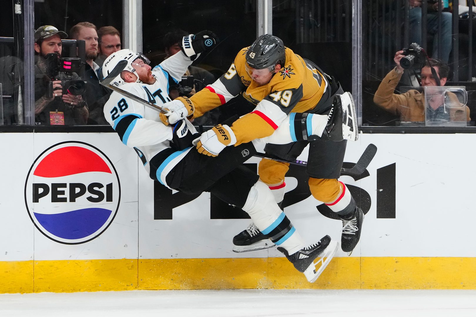 Vegas Golden Knights left wing Ivan Barbashev checks Utah Mammoth defenseman Ian Cole along the boards during the first period of Game 1 of the 2026 Stanley Cup Playoffs at T-Mobile Arena.