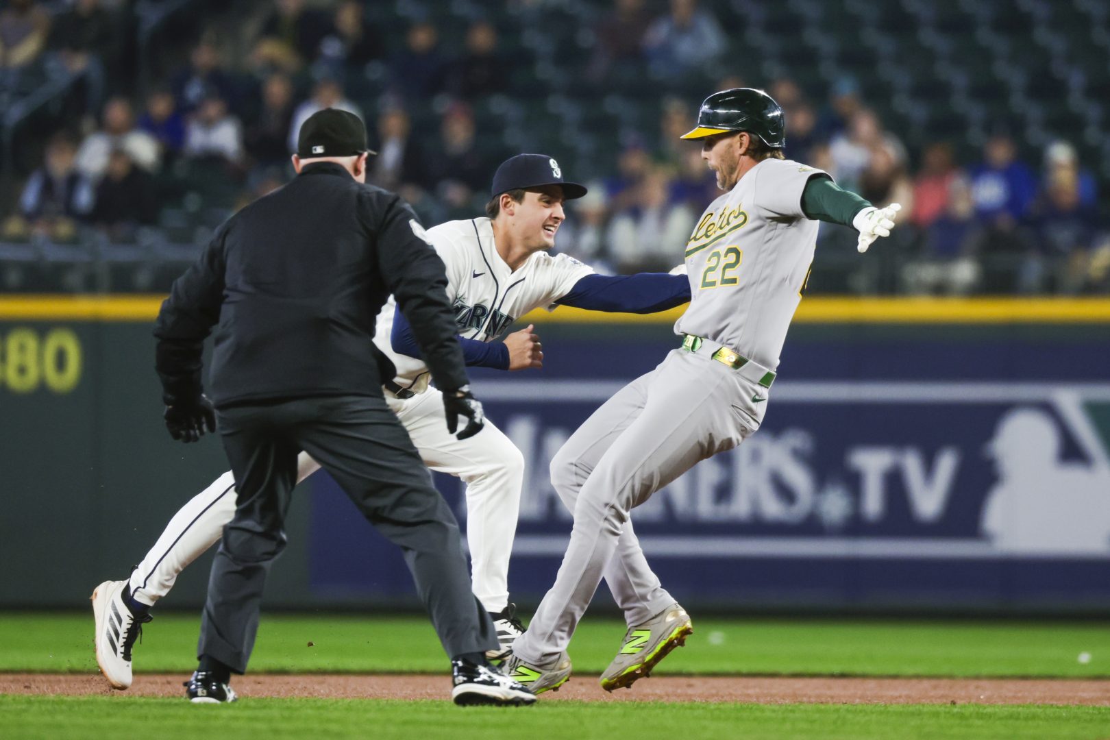 Seattle Mariners second baseman Cole Young applies a tag to Athletics second baseman Jeff McNeil during a rundown in the first inning at T-Mobile Park.