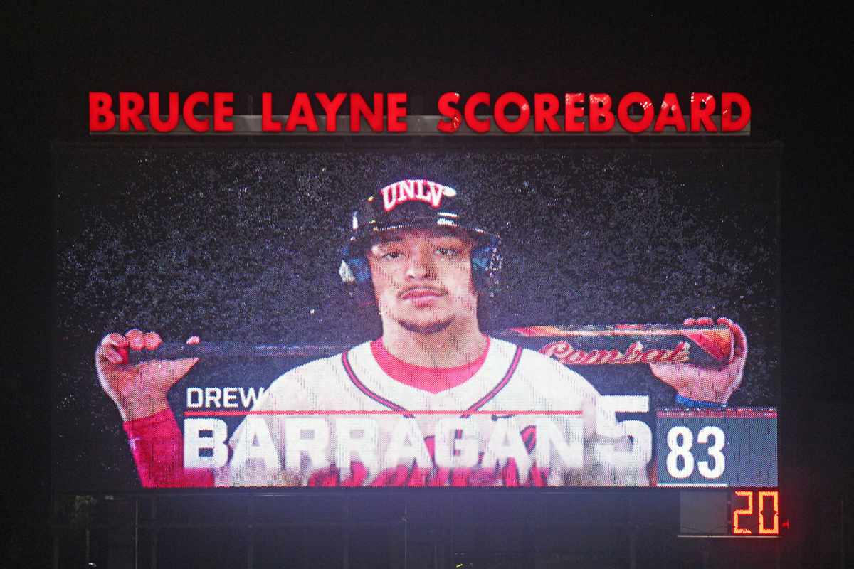 UNLV’s Drew Barragan appears on the Bruce Layne Scoreboard at Earl E. Wilson Stadium, holding a bat across his shoulders during a player intro graphic.