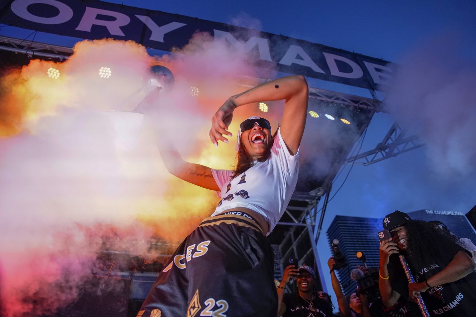 A’ja Wilson celebrates on stage during the Las Vegas Aces championship parade on the Las Vegas Strip.