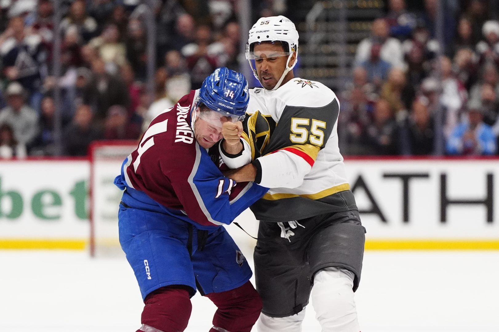 Keegan Kolesar of the Vegas Golden Knights fights Chris Wagner of the Colorado Avalanche during a game at Ball Arena.
