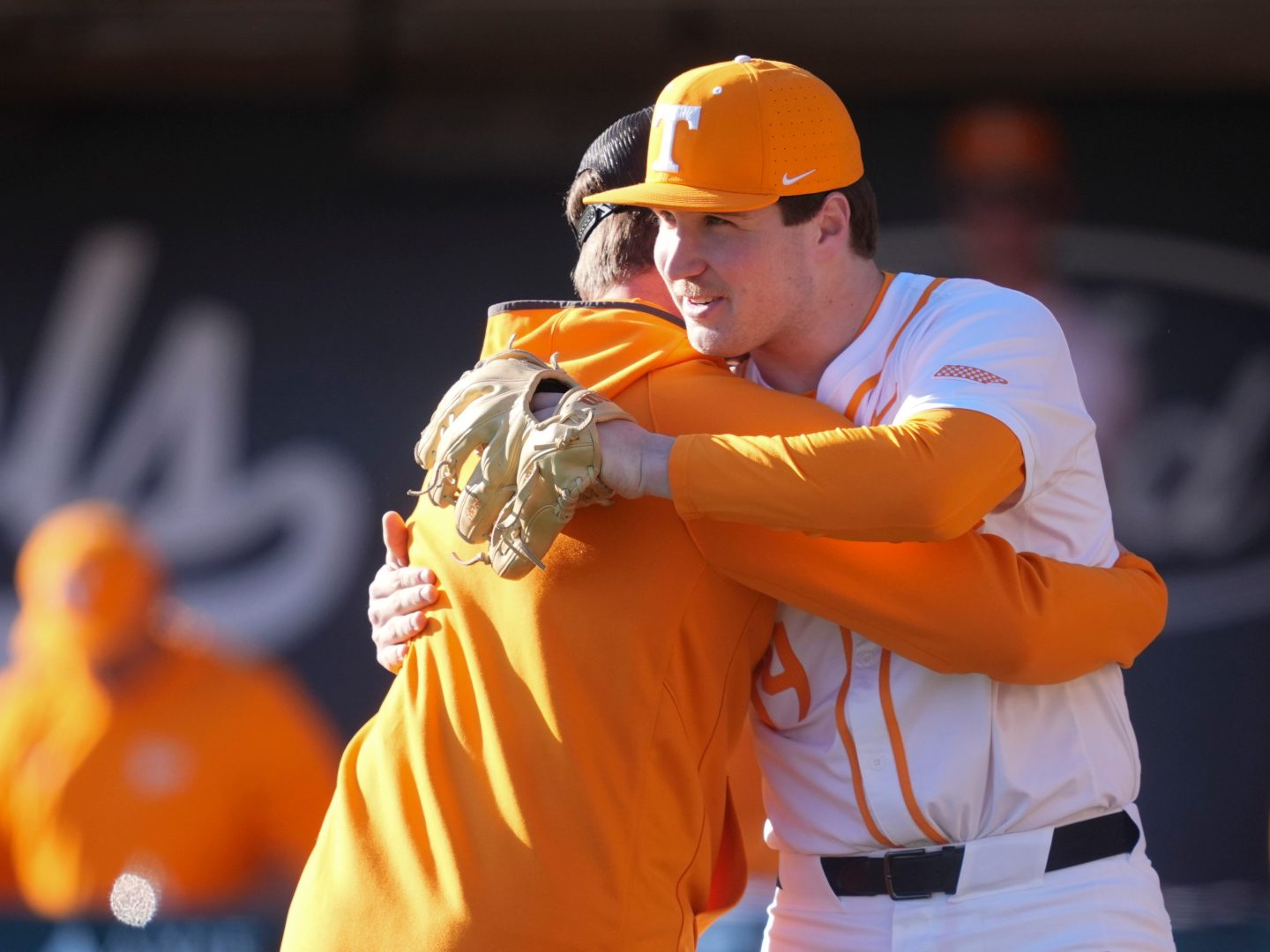 Jared Dickey embraces Tennessee pitcher Brayden Krenzel after throwing the ceremonial first pitch before a Tennessee home game at Lindsey Nelson Stadium.