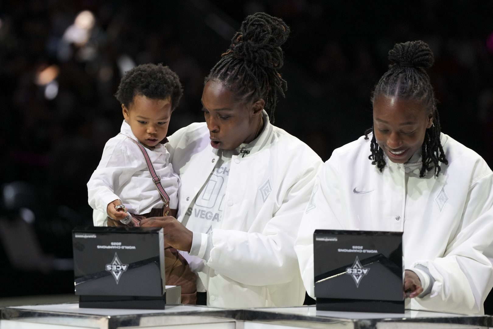 Chelsea Gray, her son Lennox Ali'i Gray and Jewell Loyd react while receiving 2025 WNBA championship rings before the Las Vegas Aces’ game against the Phoenix Mercury.