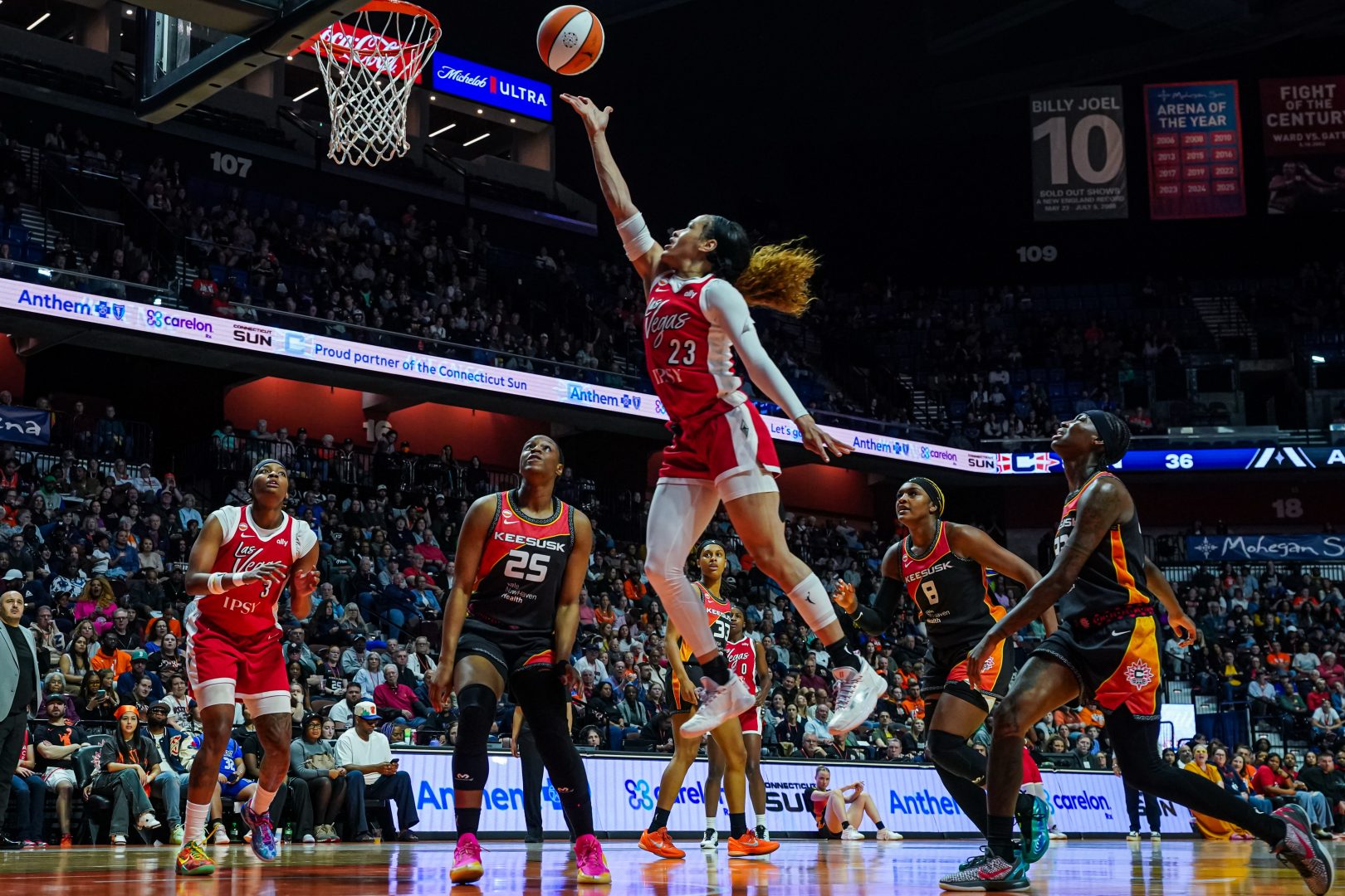 Chennedy Carter drives to the basket for the Las Vegas Aces during a road game against the Connecticut Sun.