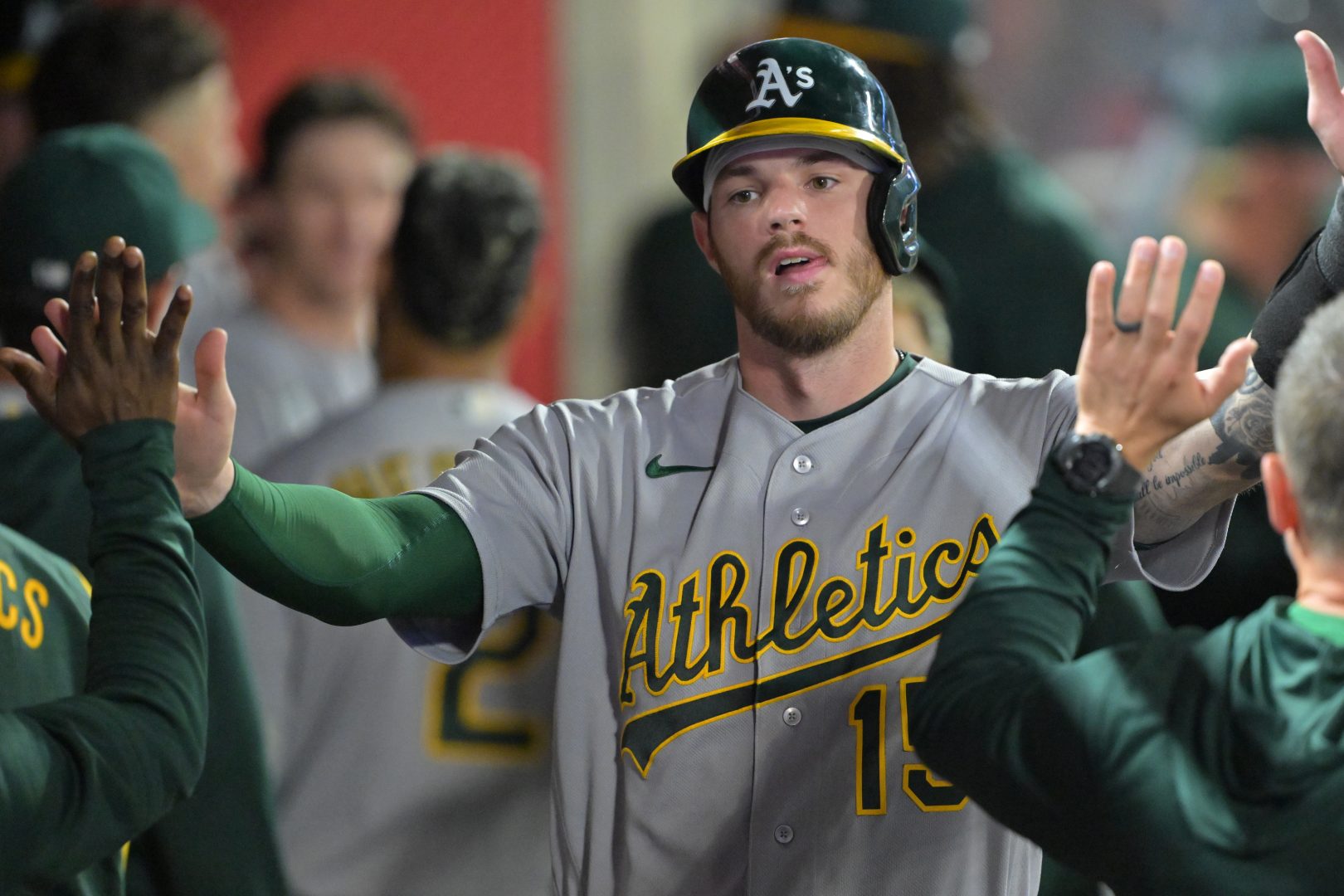 Athletics catcher Jonah Heim celebrates in the dugout after scoring on a Nick Kurtz RBI single during the sixth inning against the Los Angeles Angels at Angel Stadium.