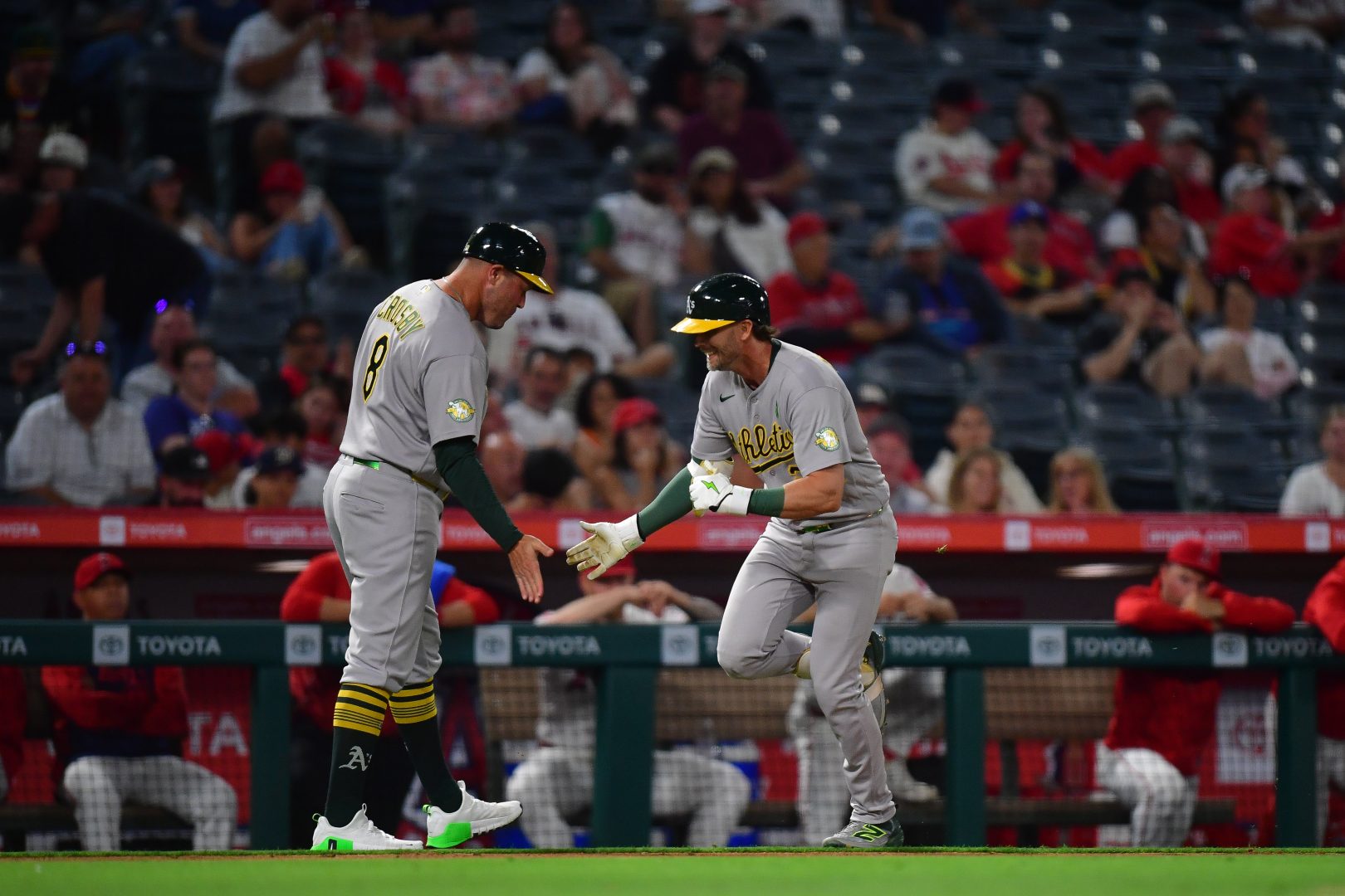Athletics 2B Jeff McNeil is greeted by 3B coach Bobby Crosby after McNeil’s ninth-inning solo homer vs. the Angels at Angel Stadium on May 20, 2026.