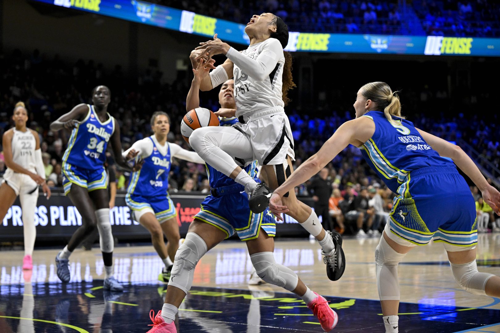 Dallas Wings guards Azzi Fudd and Paige Bueckers knock the ball away from Las Vegas Aces guard Chennedy Carter during the second half at College Park Center.