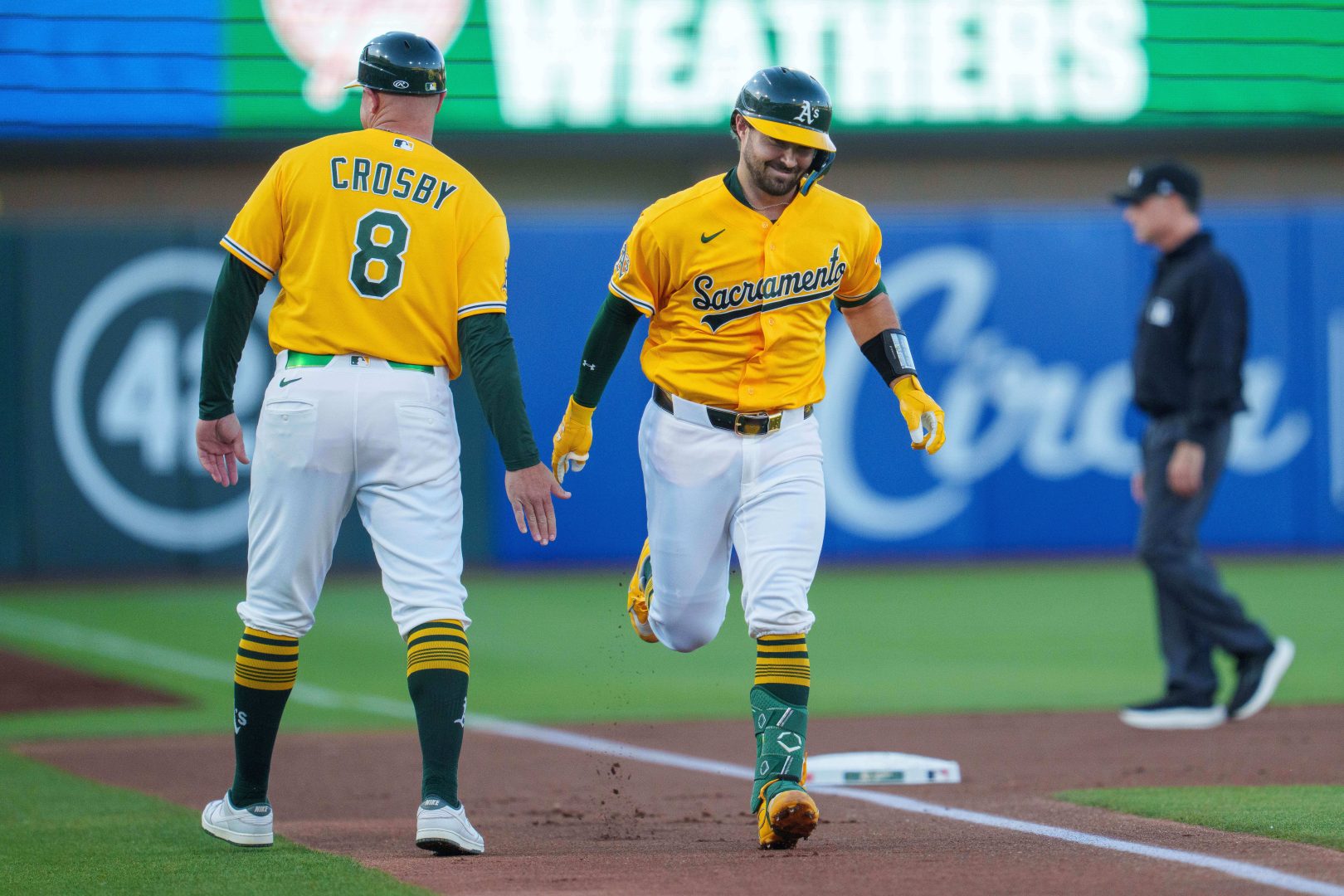 Shea Langeliers is congratulated by third base coach Bobby Crosby after hitting a two-run home run in the first inning against the Yankees at Sutter Health Park.