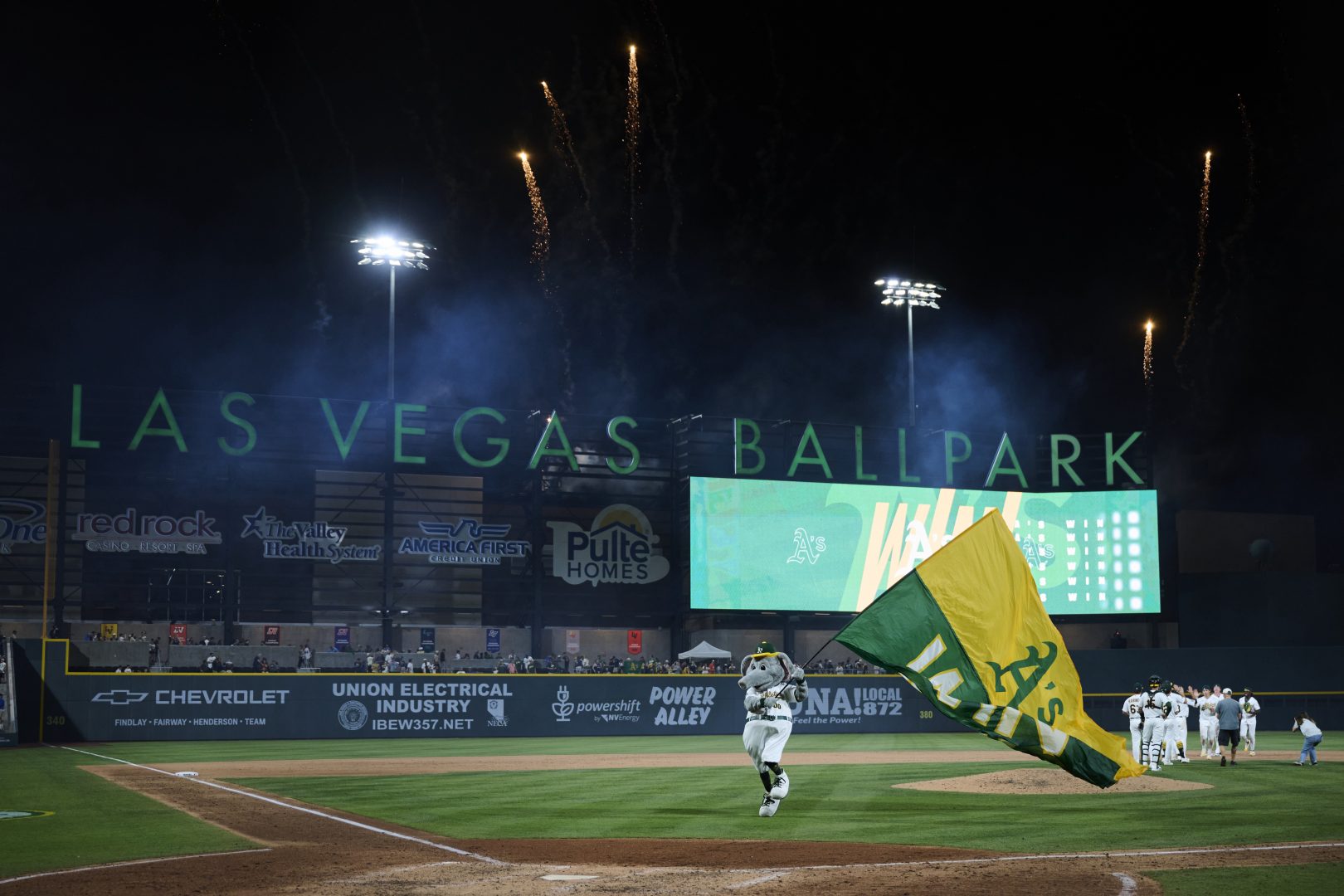 The Athletics mascot Stomper waves a victory flag