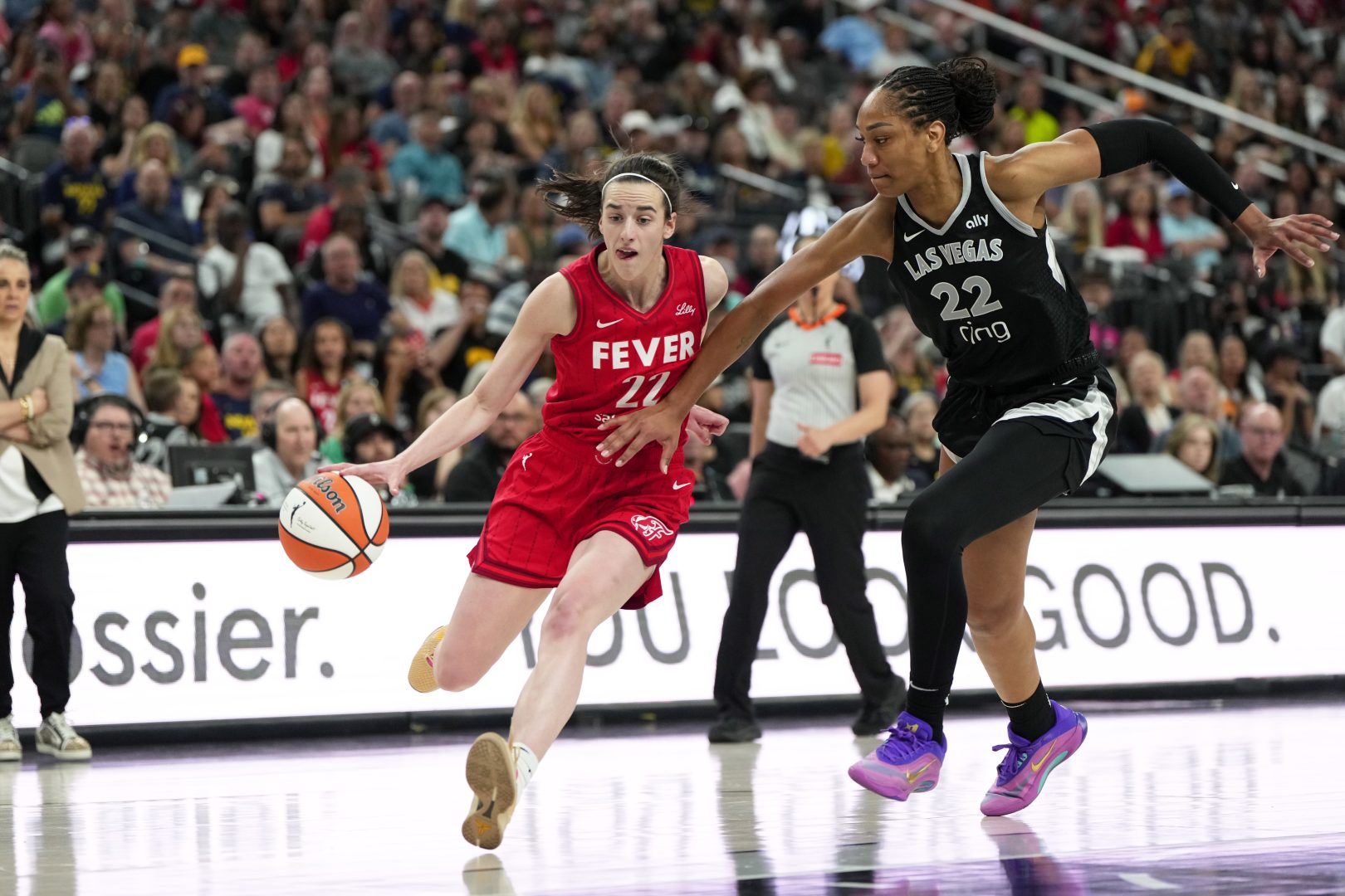 Caitlin Clark dribbles against A’ja Wilson during the second half of a Fever-Aces game at T-Mobile Arena.