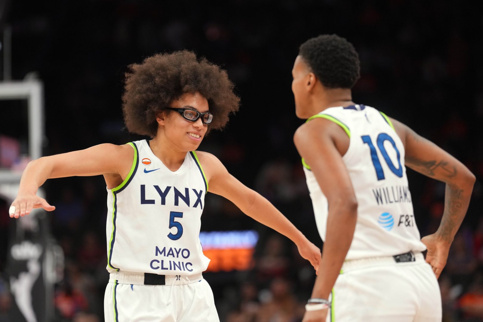 Minnesota Lynx guards Courtney Williams and Olivia Miles slap hands during the second half against the Phoenix Mercury.