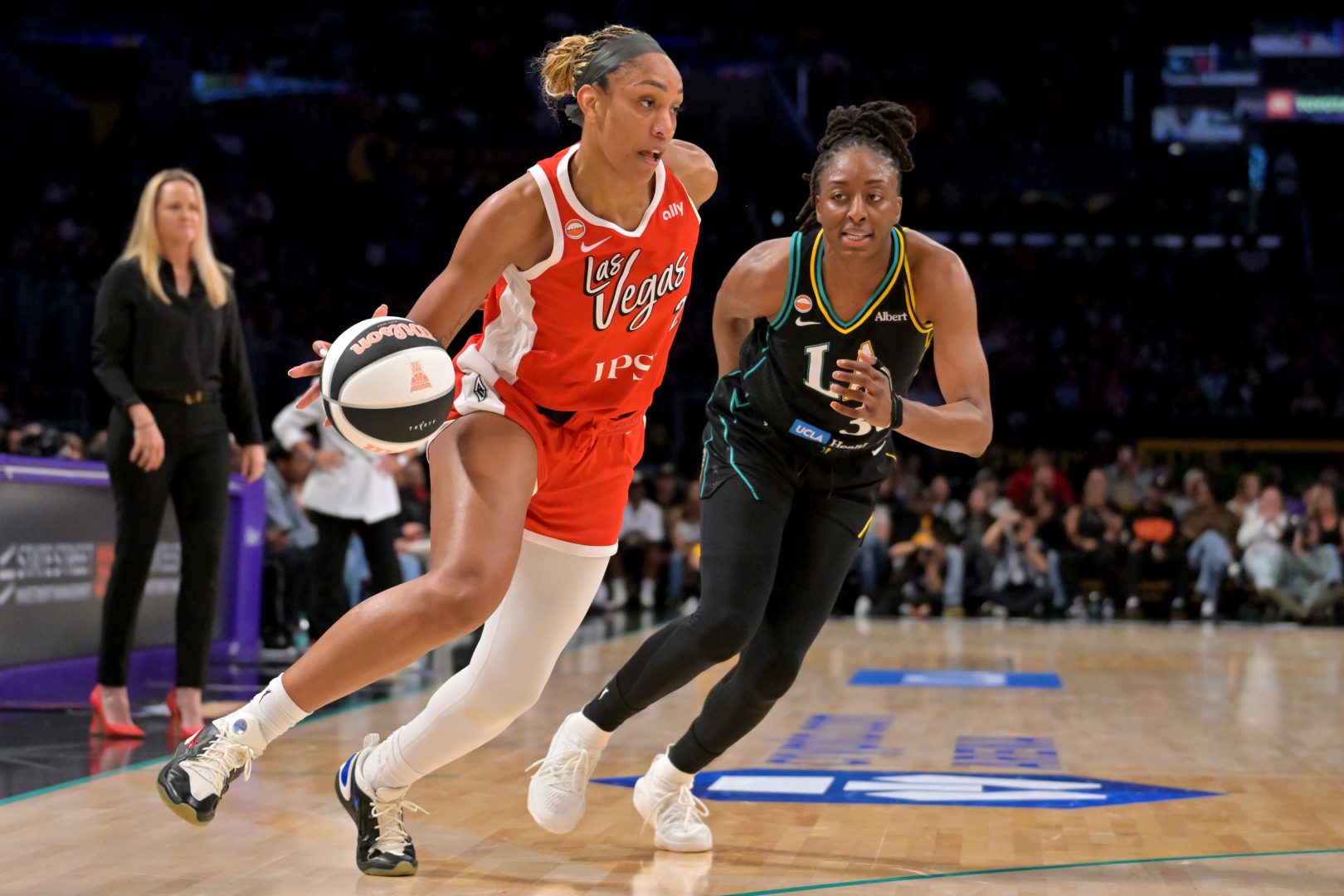 Las Vegas Aces center A’ja Wilson drives to the basket while defended by Los Angeles Sparks forward Nneka Ogwumike during the first half at Crypto.com Arena.