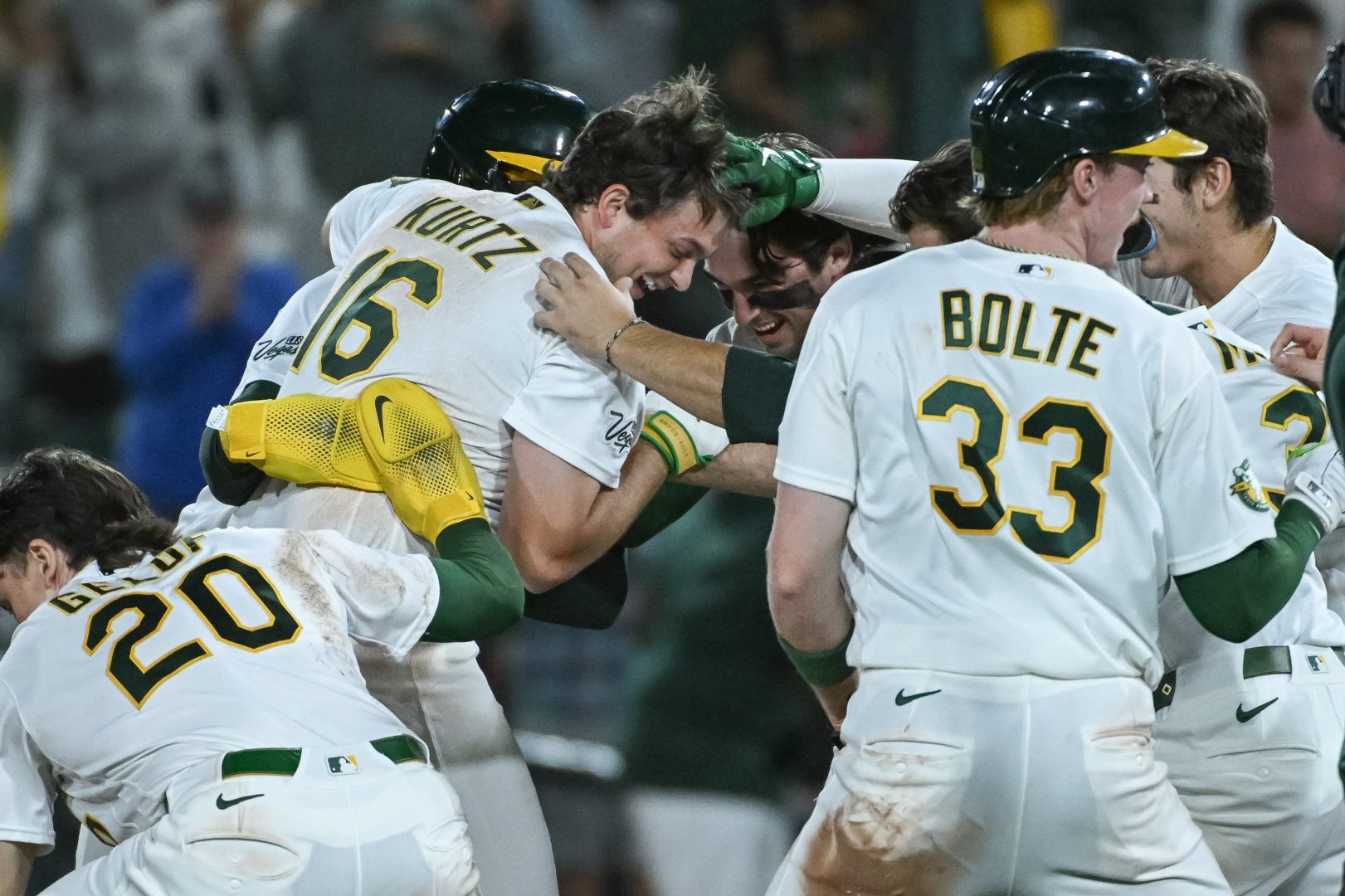Athletics first baseman Nick Kurtz celebrates with teammates after drawing a walk-off walk against the Los Angeles Angels.