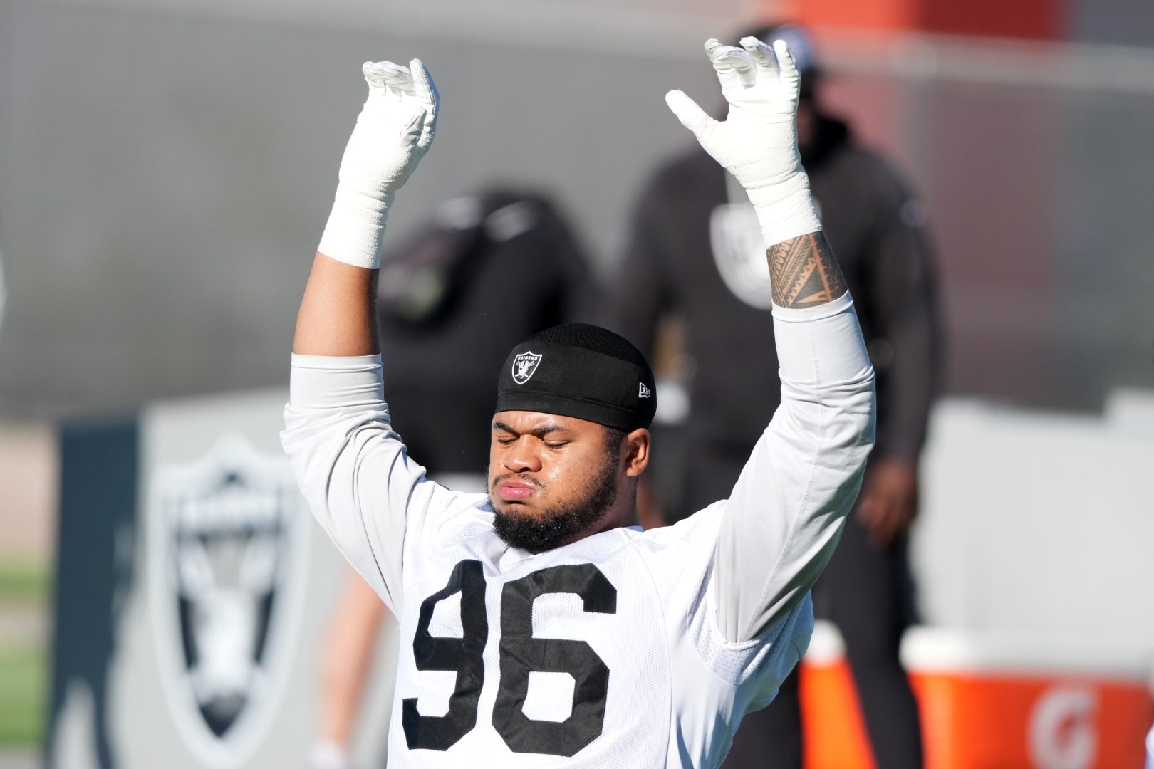 Raiders defensive tackle Jonah Laulu stretches during minicamp in Henderson.