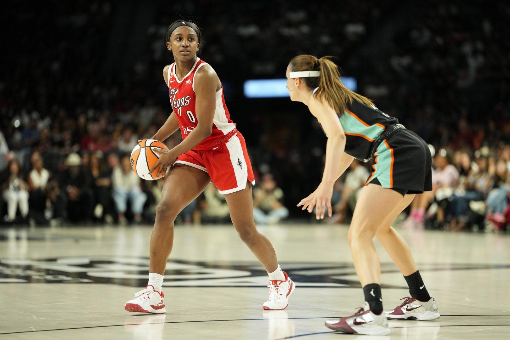 Jackie Young controls the ball against Rebecca Allen during the Aces’ July 30 game against the New York Liberty.