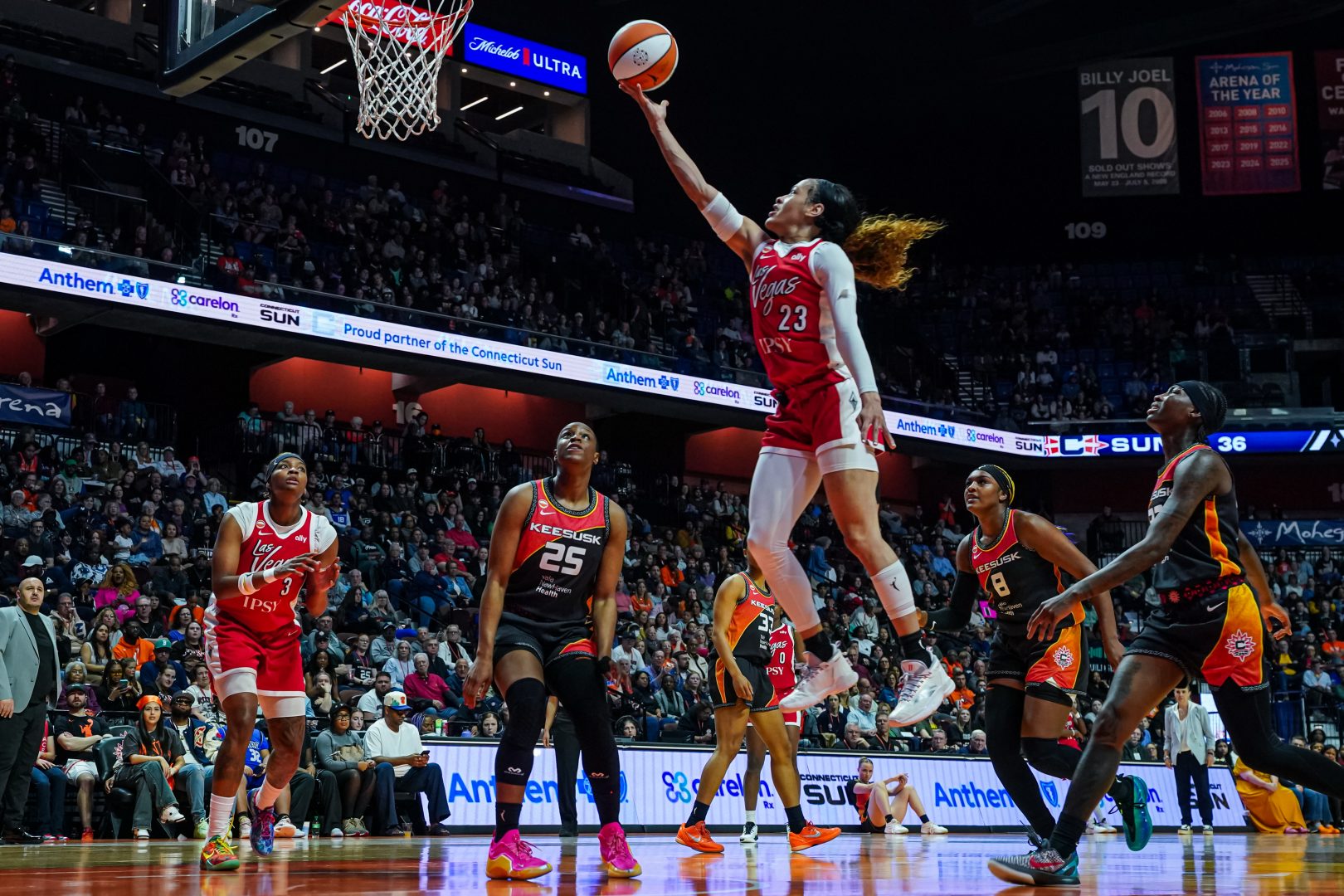 Chennedy Carter drives toward the basket for the Las Vegas Aces against the Connecticut Sun.