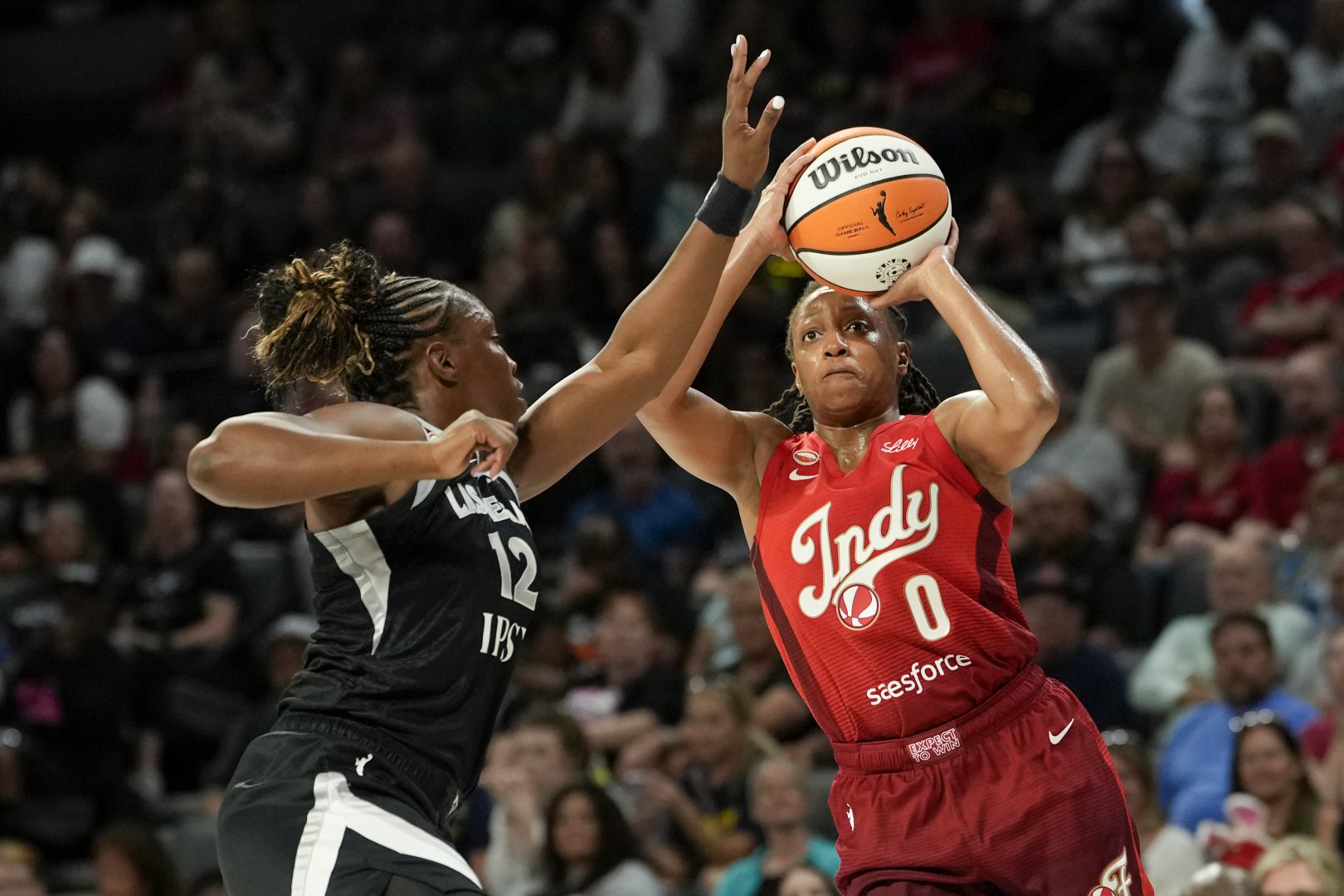 Indiana Fever guard Kelsey Mitchell shoots over Las Vegas Aces guard Chelsea Gray during the first quarter at Michelob ULTRA Arena.