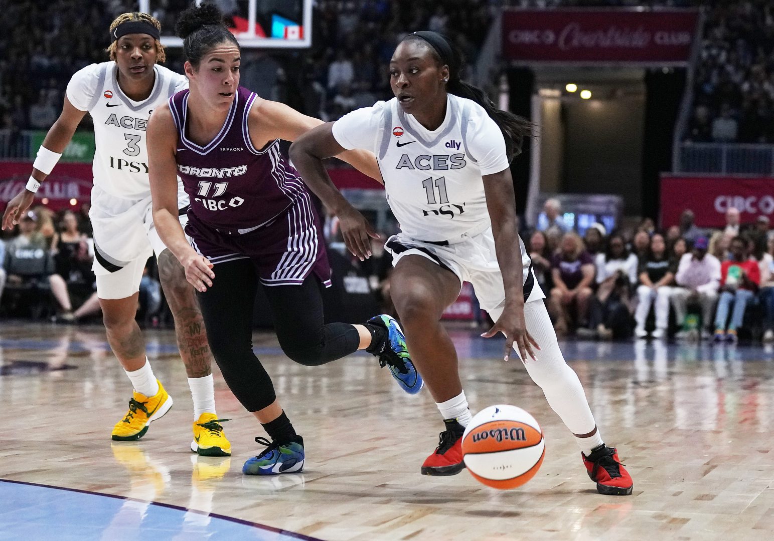 Las Vegas Aces guard Dana Evans controls the ball while Toronto Tempo guard Kia Nurse defends at Coca-Cola Coliseum