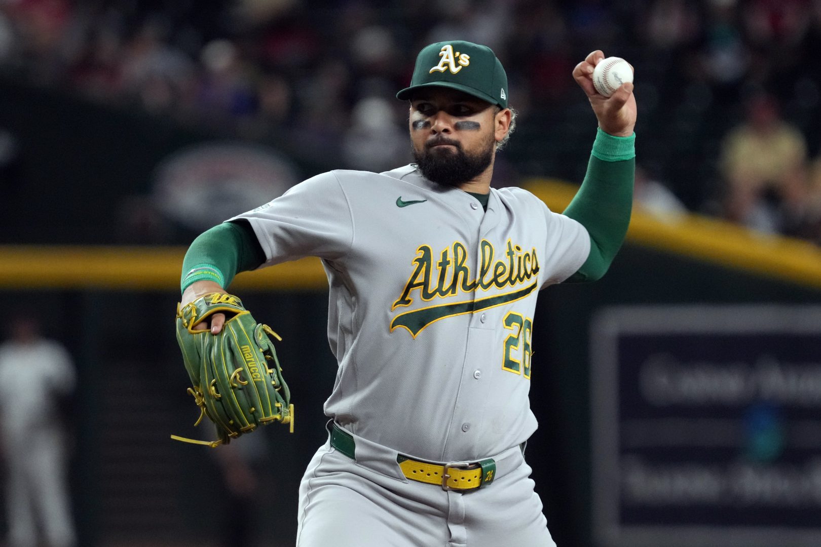 Athletics right fielder Carlos Cortes pitches against the Arizona Diamondbacks at Chase Field.