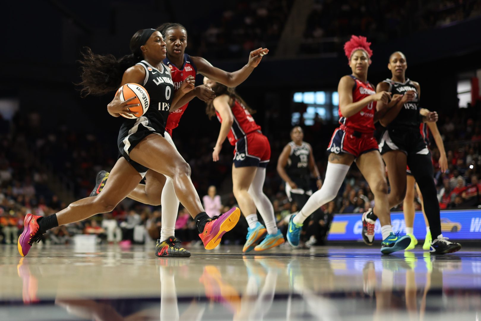 Las Vegas Aces guard Jackie Young drives to the basket against Washington Mystics forward Michaela Onyenwere during the first half at CareFirst Arena.