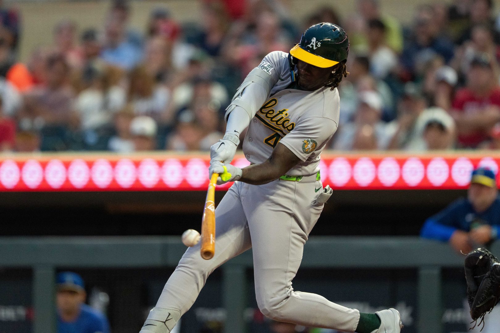 Athletics right fielder Lawrence Butler hits a sacrifice fly against the Minnesota Twins at Target Field.