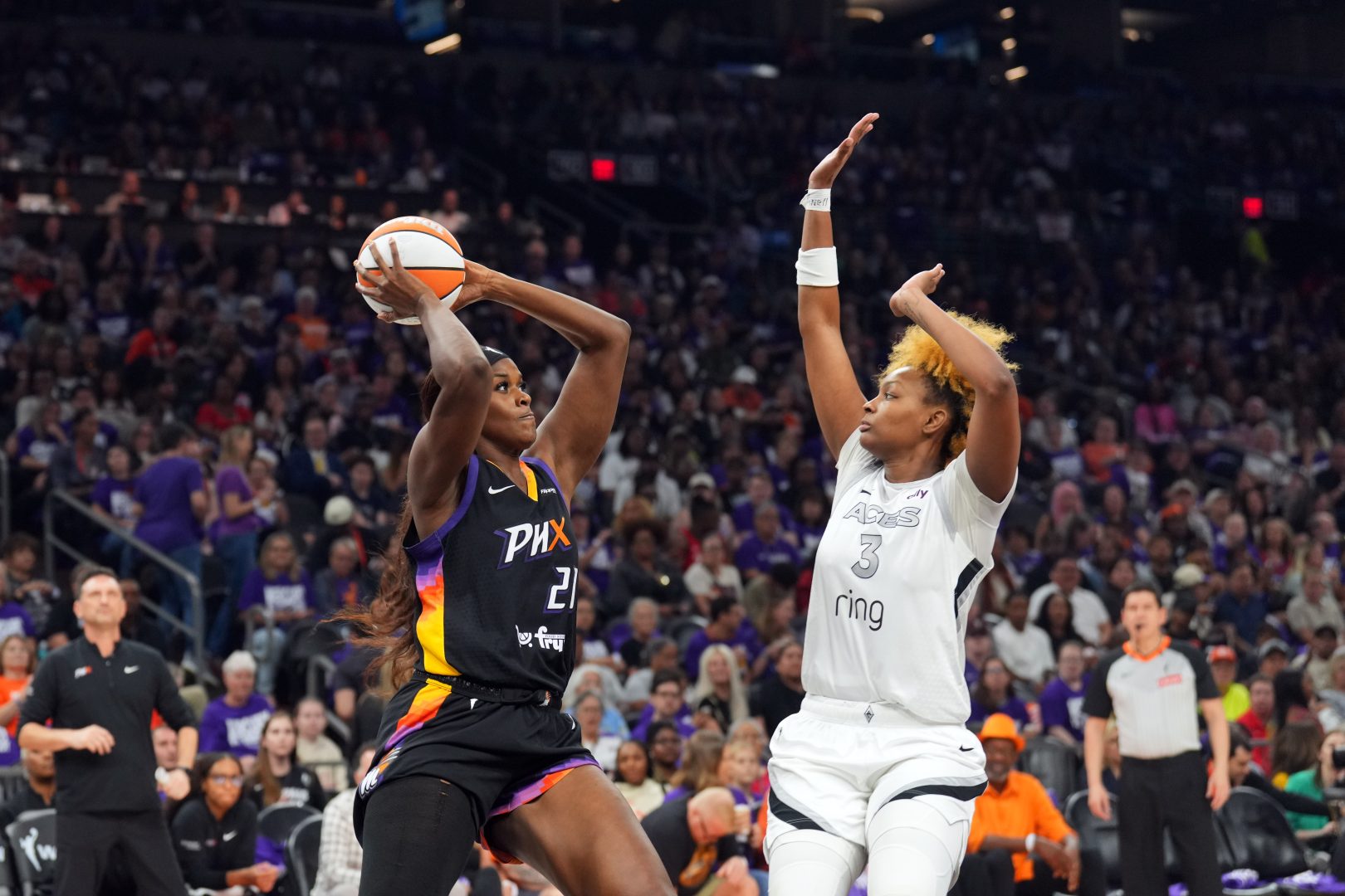 Phoenix Mercury center Kalani Brown drives against Las Vegas Aces forward NaLyssa Smith