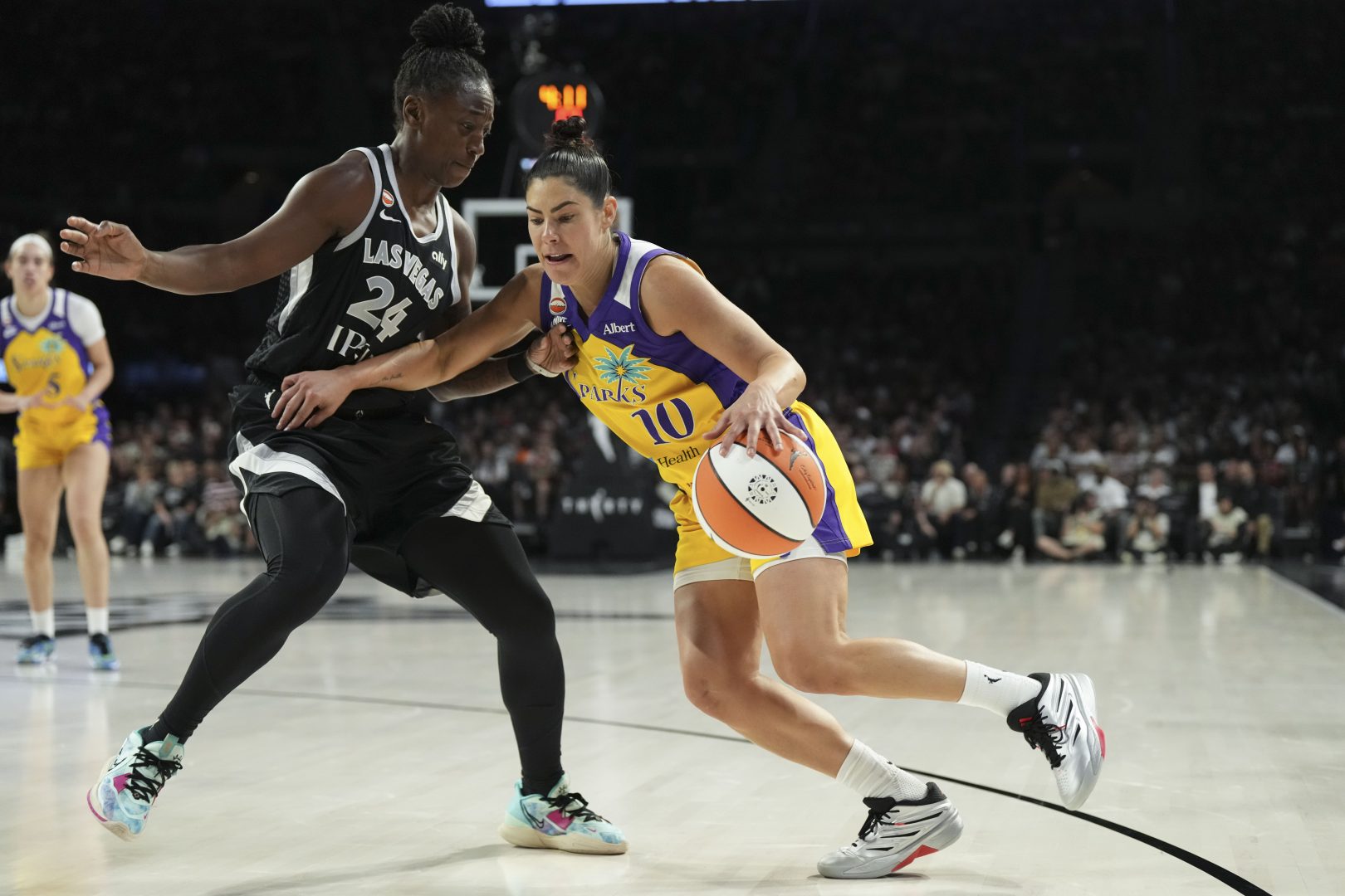 Kelsey Plum drives against Jewell Loyd during a Los Angeles Sparks game against the Las Vegas Aces.