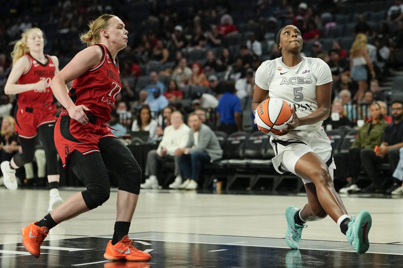 Las Vegas Aces guard Ta'Niya Latson drives against Portland Fire guard Holly Winterburn