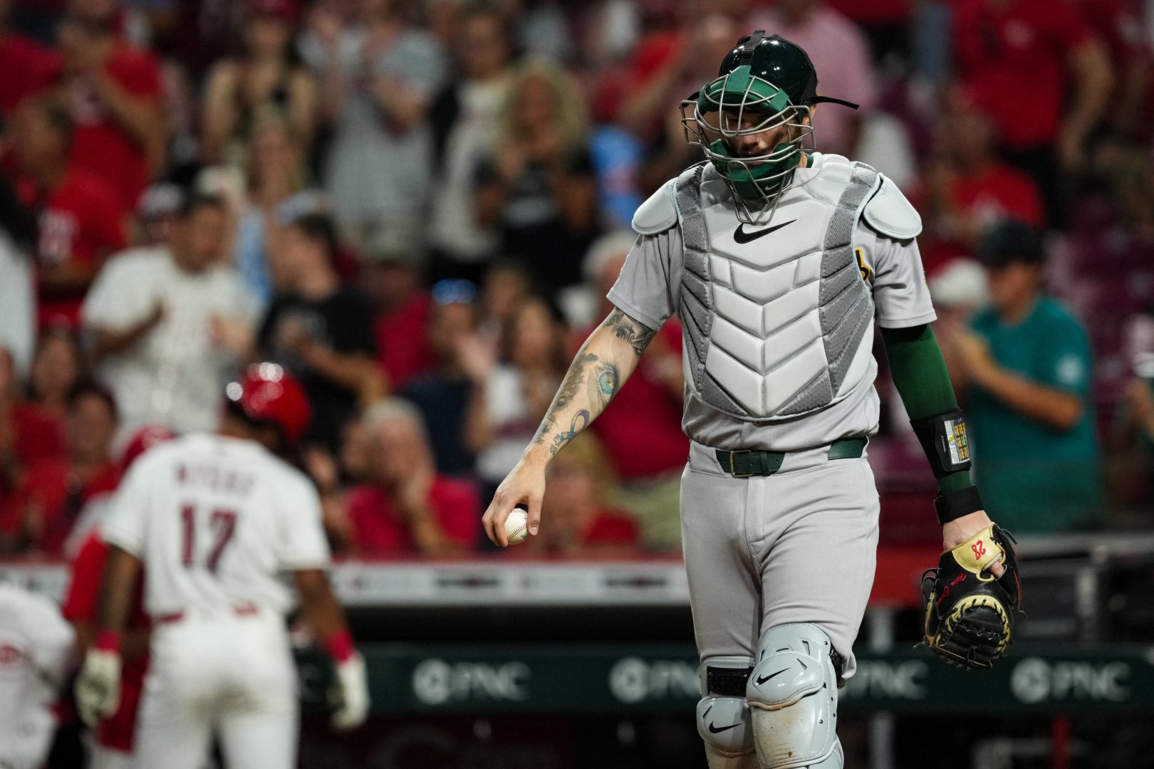 Athletics catcher Jonah Heim reacts after Cincinnati scores the go-ahead run in the eighth inning at Great American Ball Park.