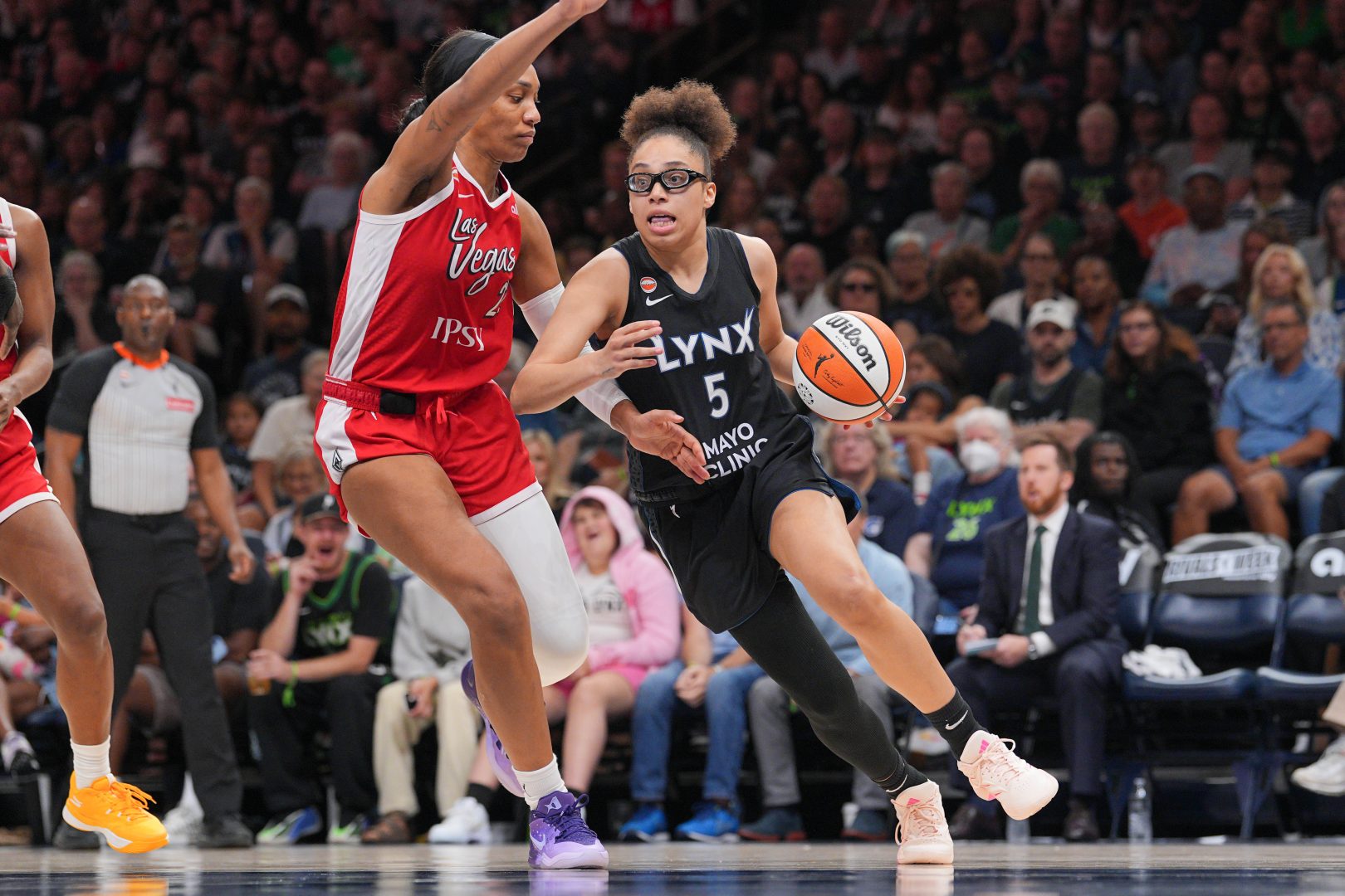 Minnesota Lynx forward Olivia Miles dribbles against Las Vegas Aces forward A'ja Wilson