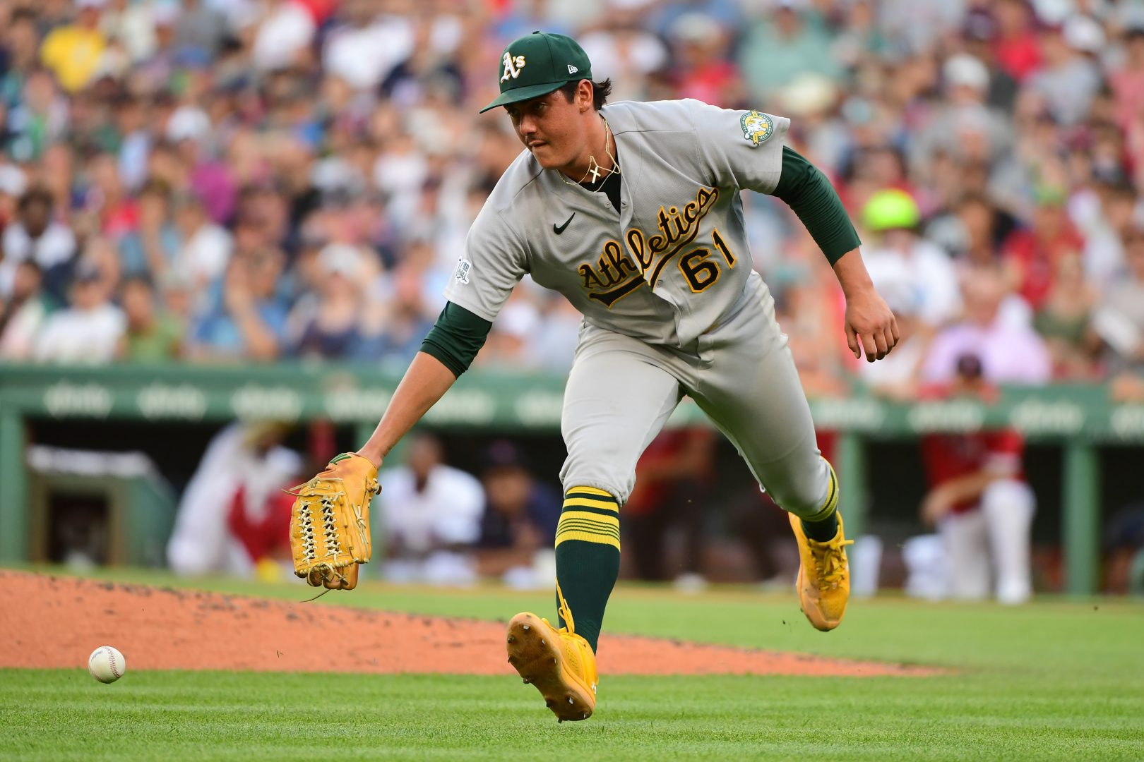 Athletics pitcher Gage Jump reaches for the ball during the sixth inning against the Boston Red Sox
