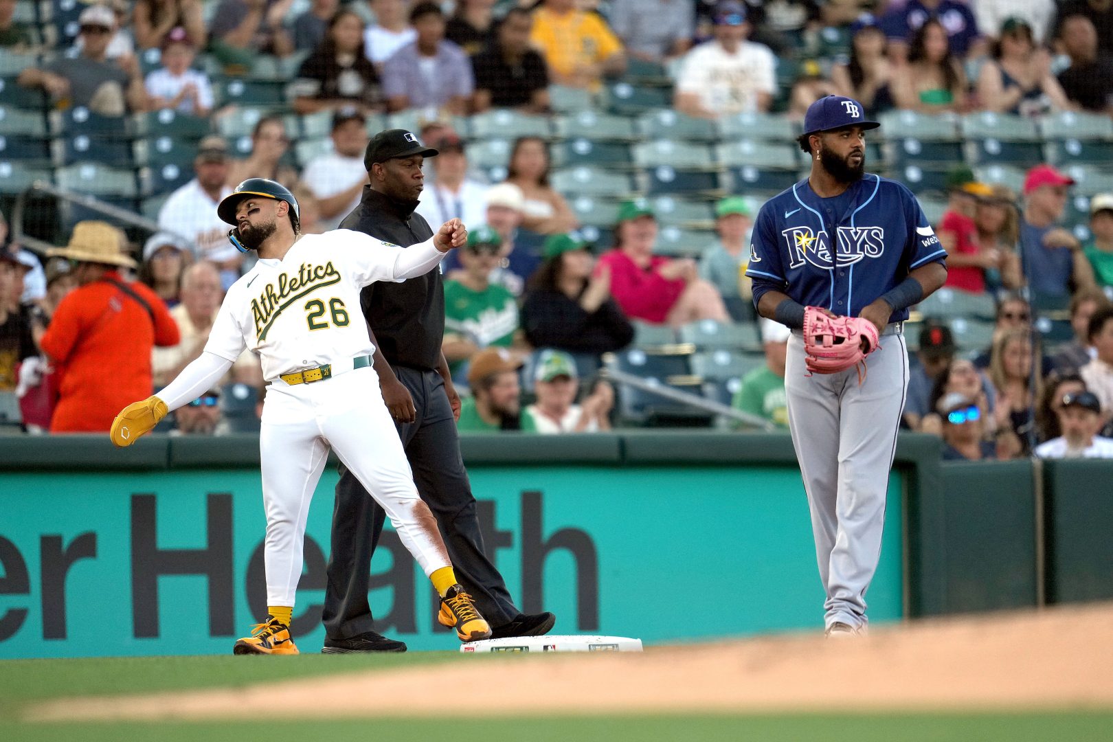 Athletics right fielder Carlos Cortes stands at third base next to Rays third baseman Junior Caminero
