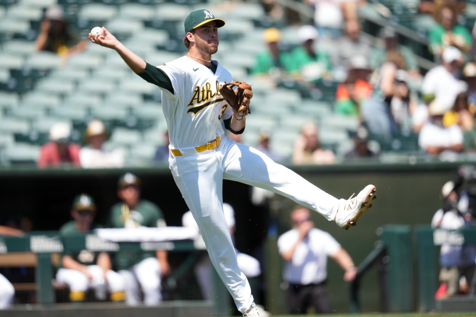 Athletics third baseman Max Muncy throws to first against the Tampa Bay Rays