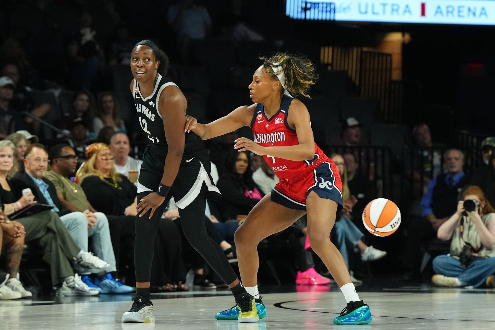 Chelsea Gray passes around Alex Wilson during the first quarter at Michelob ULTRA Arena.