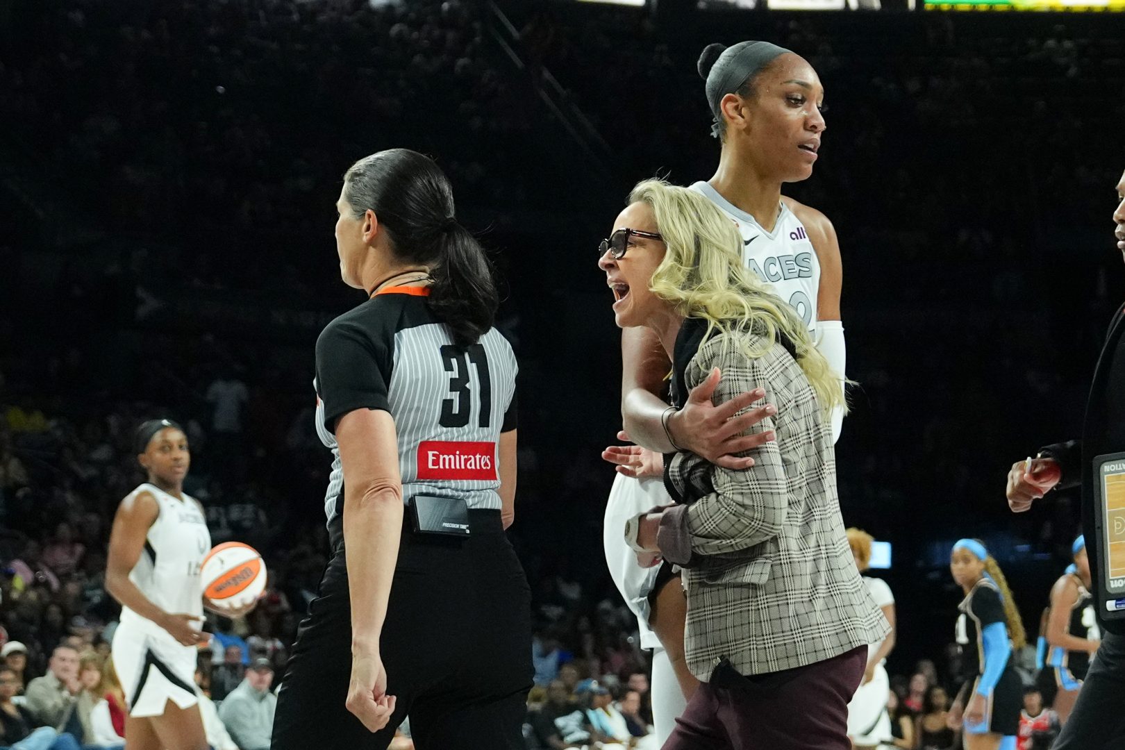 A’ja Wilson holds back Aces coach Becky Hammon during the second quarter against the Atlanta Dream.