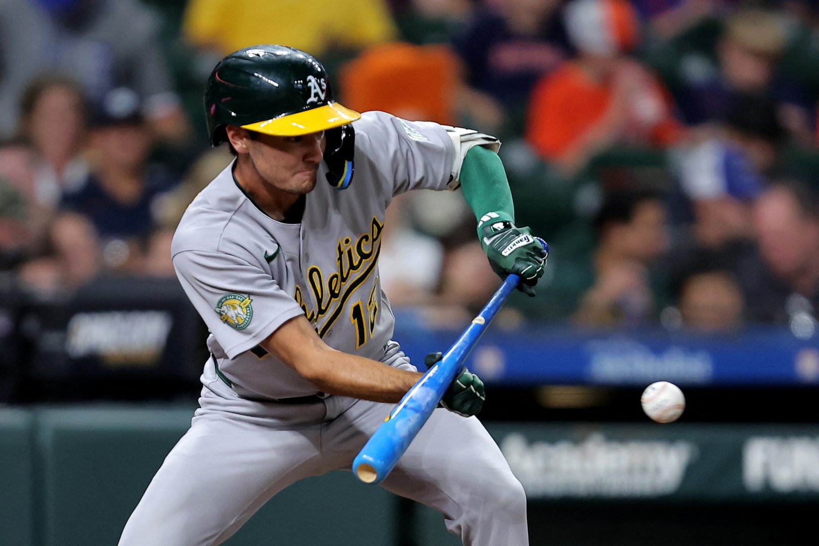Athletics pinch hitter Alika Williams bunts against the Houston Astros