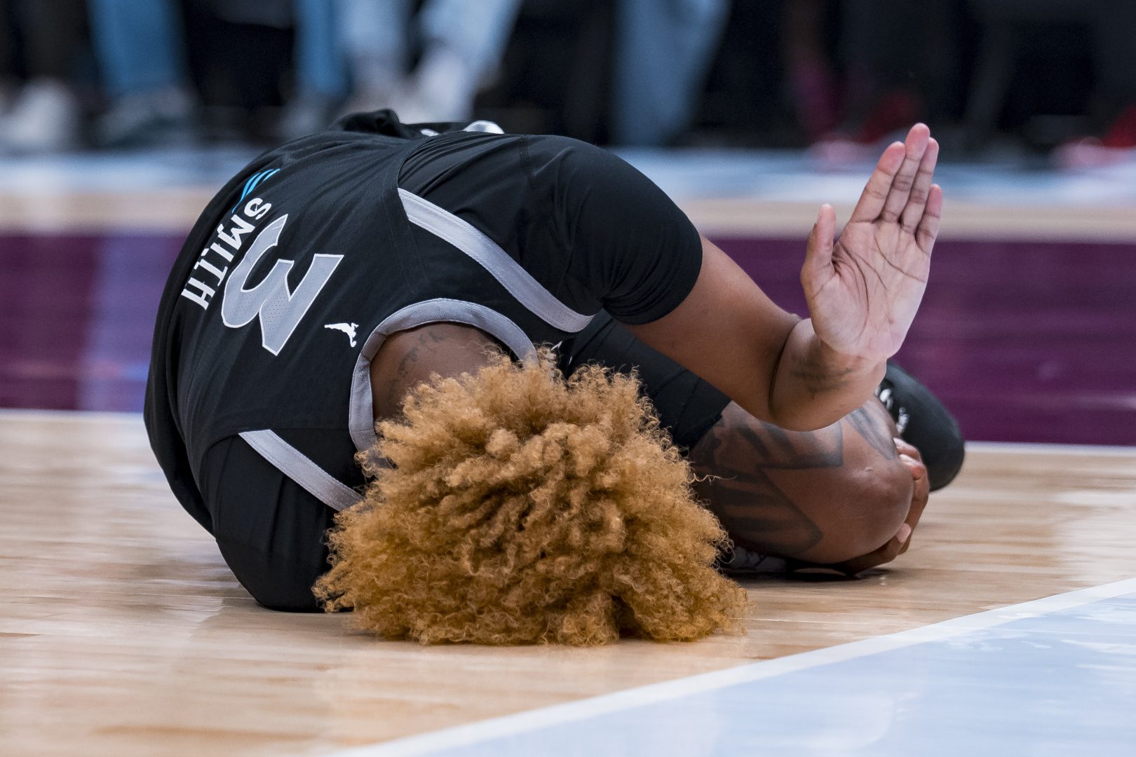 Las Vegas Aces forward NaLyssa Smith reacts after being injured during the second half against the Toronto Tempo at Rogers Arena in Vancouver.