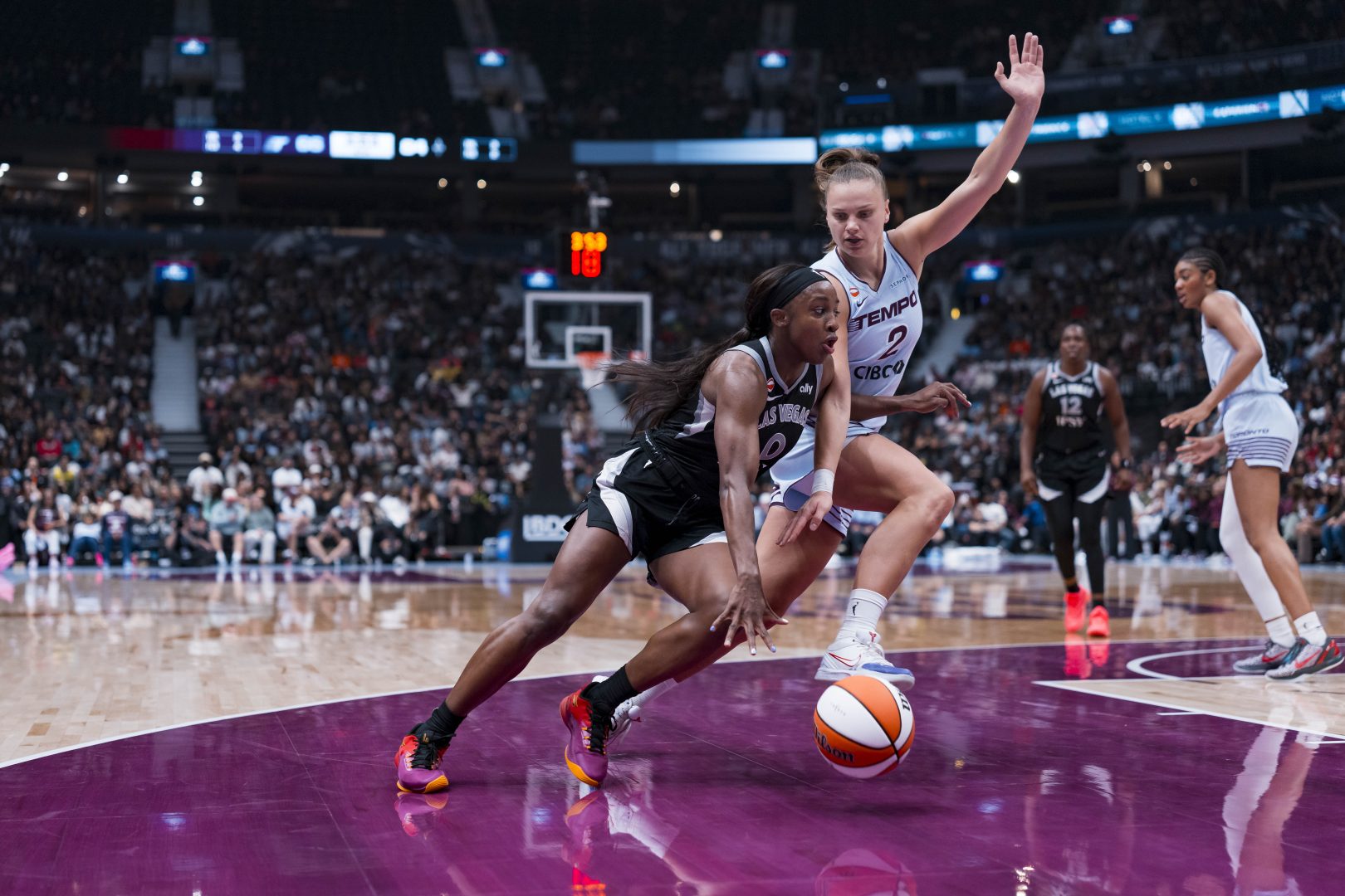 Las Vegas Aces guard Jackie Young drives past Toronto Tempo forward Laura Juskaite