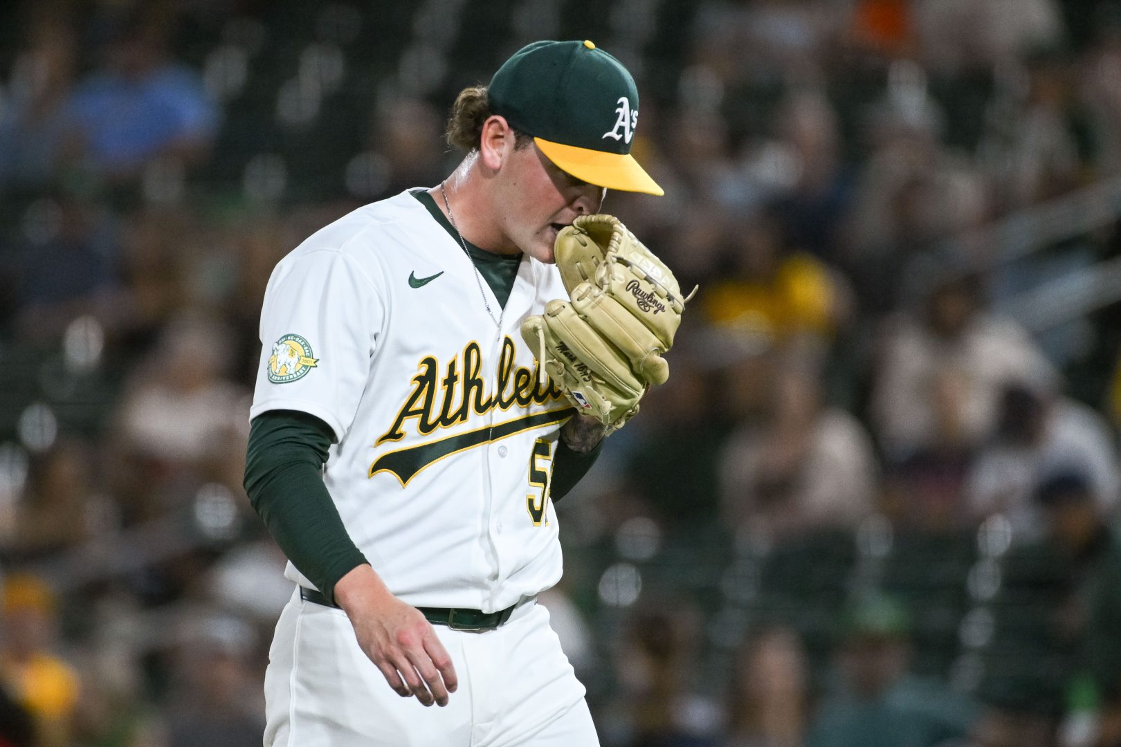 Athletics pitcher Hayden Juenger reacts after being removed against the Minnesota Twins
